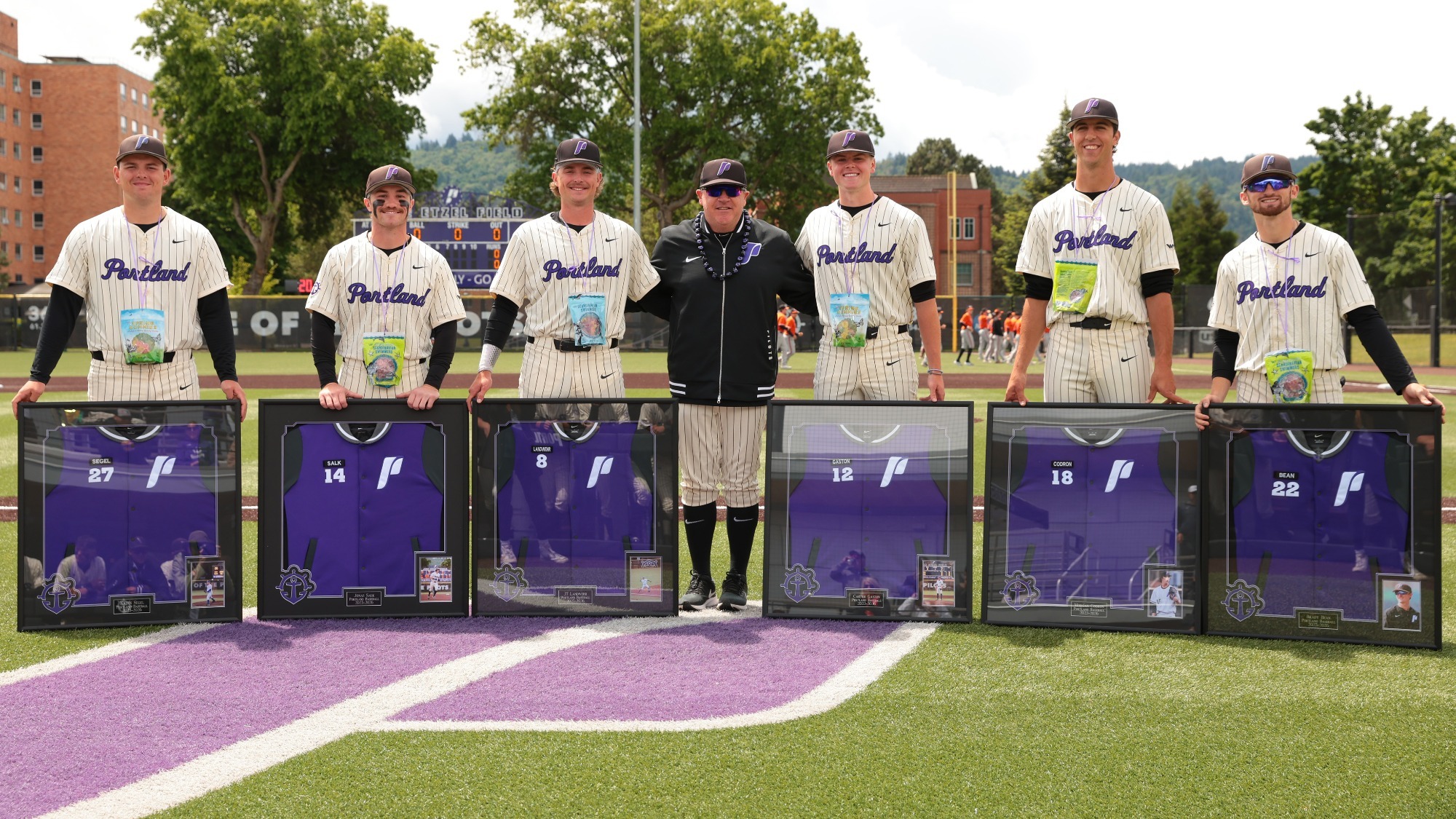 Portland's six baseball seniors pose with head coach Geoff Loomis following Senior Day pregame recognition on May 16, 2026 at Joe Etzel Field.