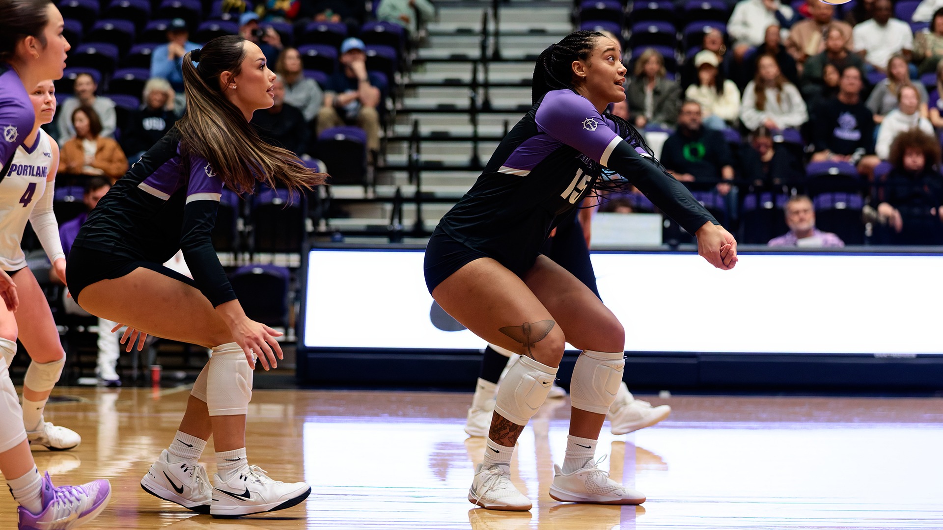 Nevaeh Bray receives a serve in contest against San Diego.
