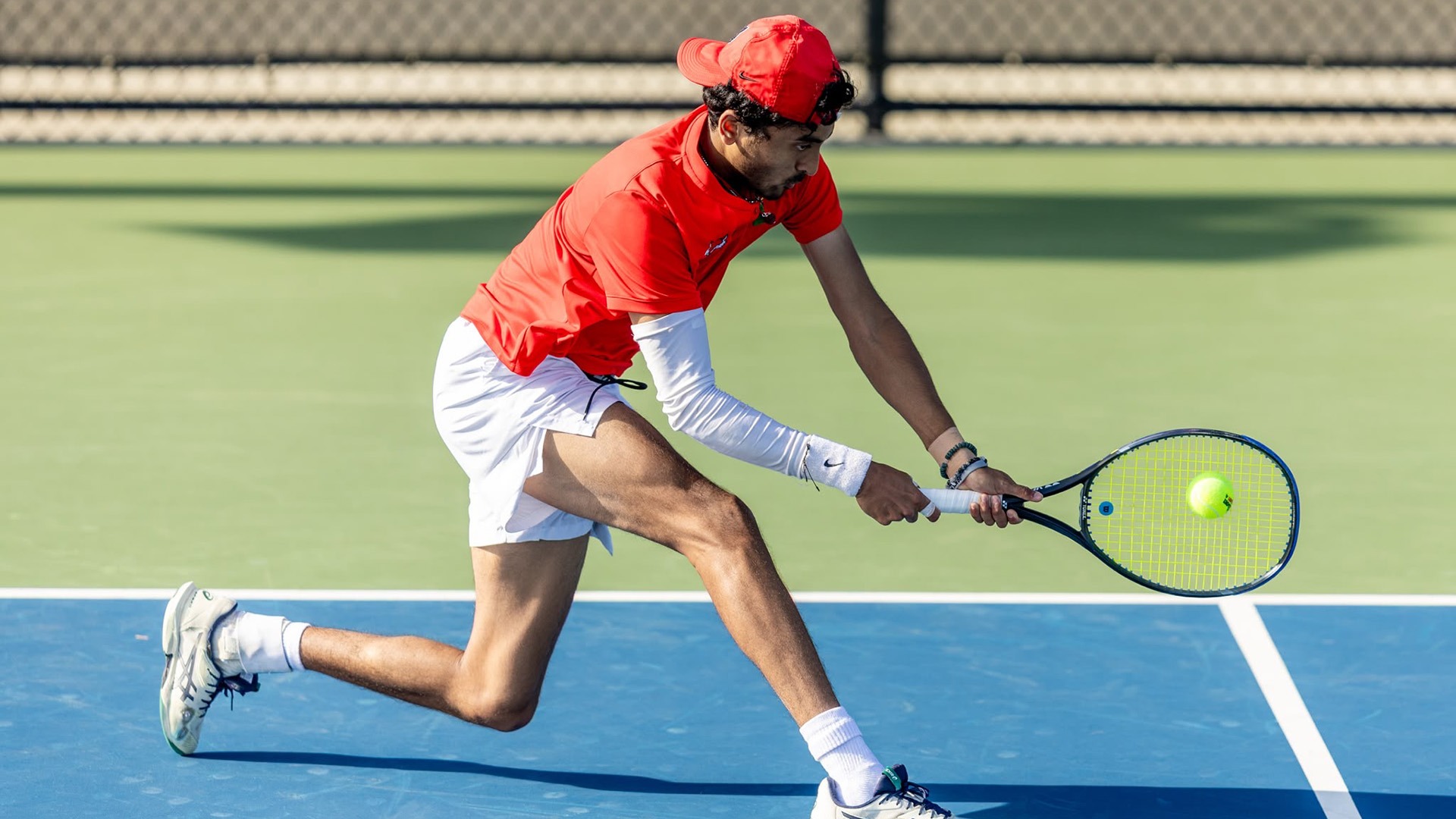 Nallaparaju hits a lunging backhand while competing for Marist.