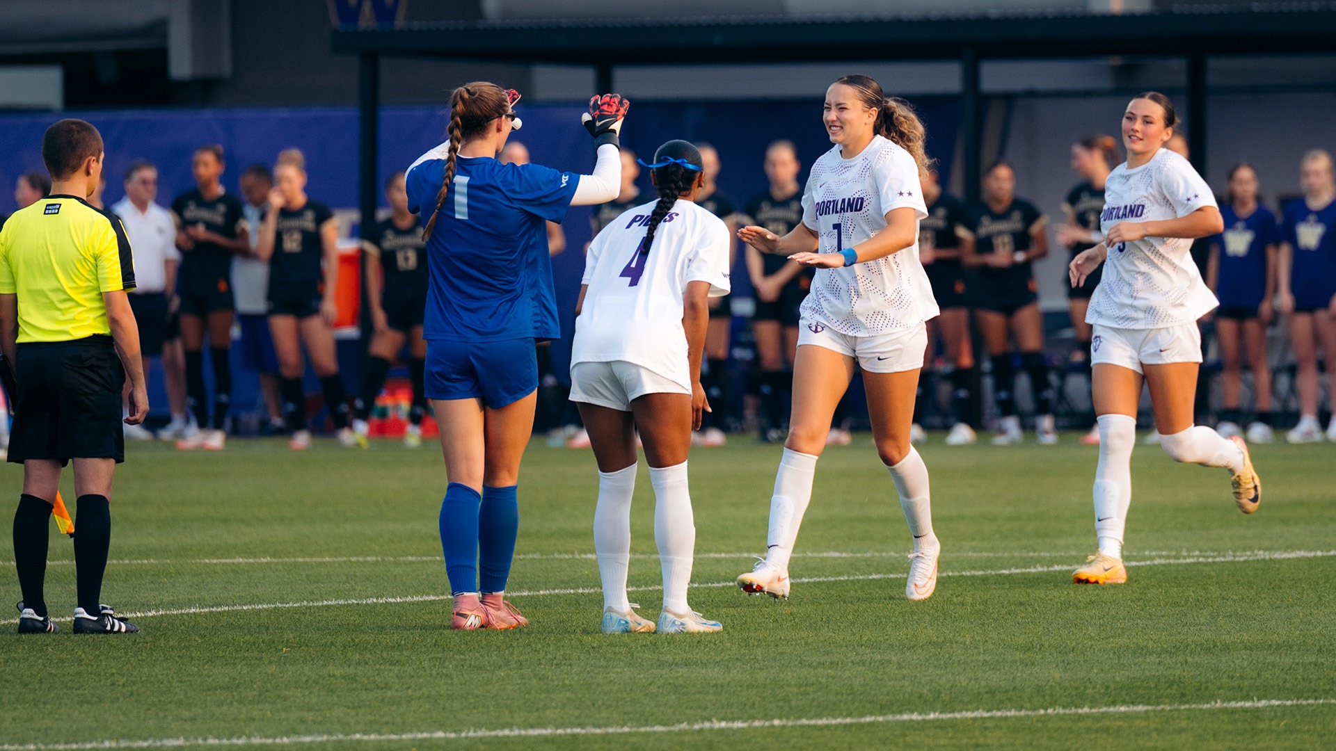 Xayla Black celebrates with teammates during a road match.
