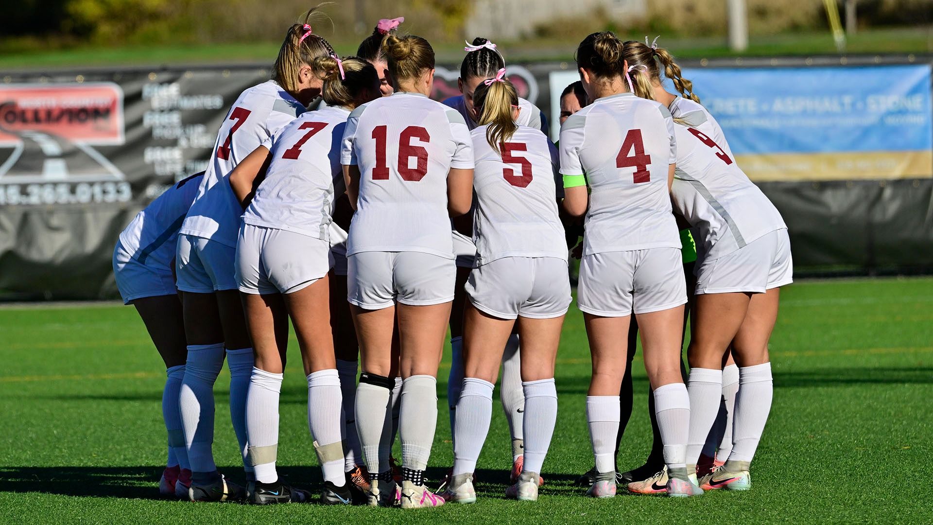 The women's soccer team huddles before a game with Oswego on 10/15/15.