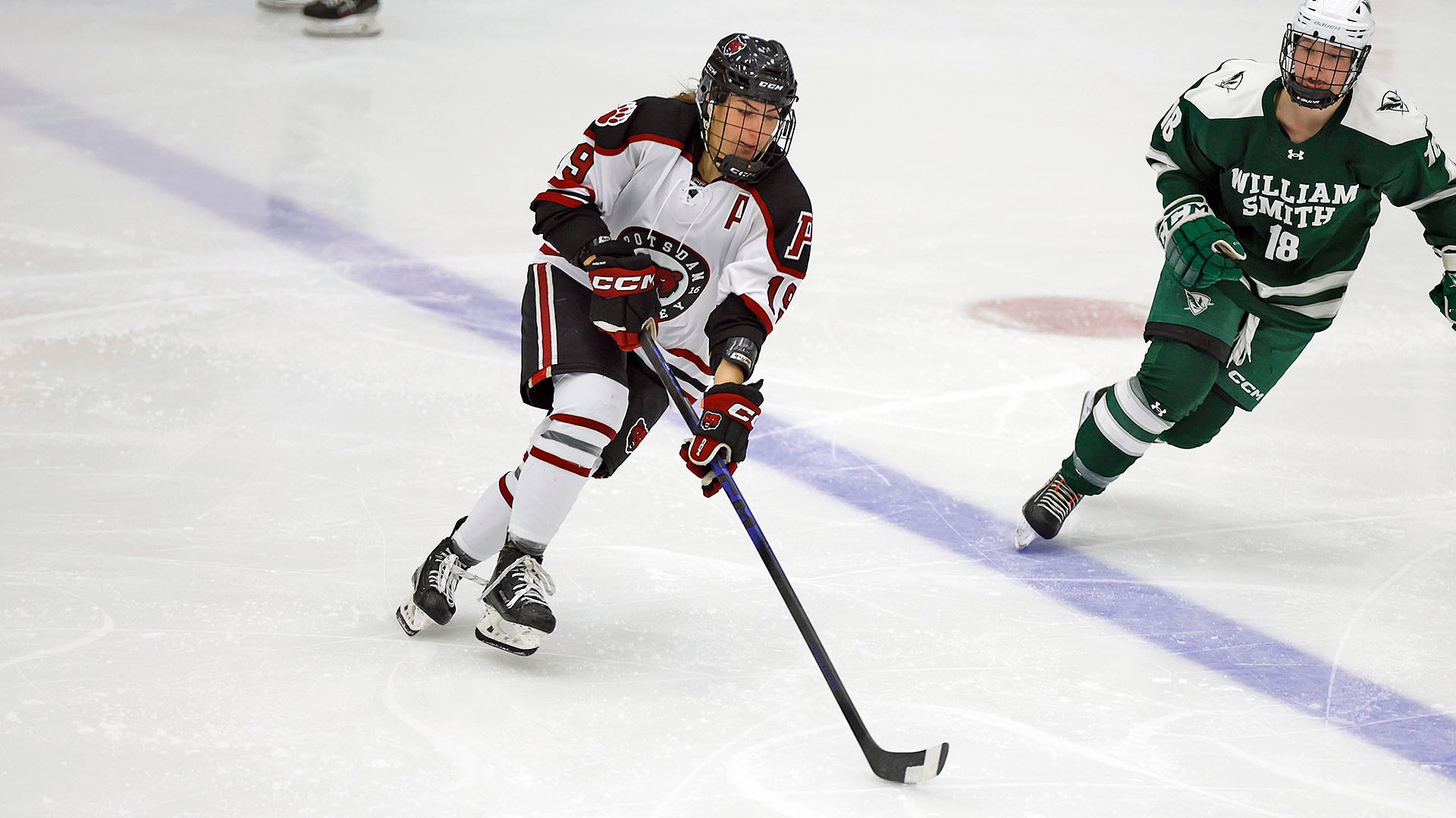 Alessia Marandola carries the puck against William Smith on 11/15/25.