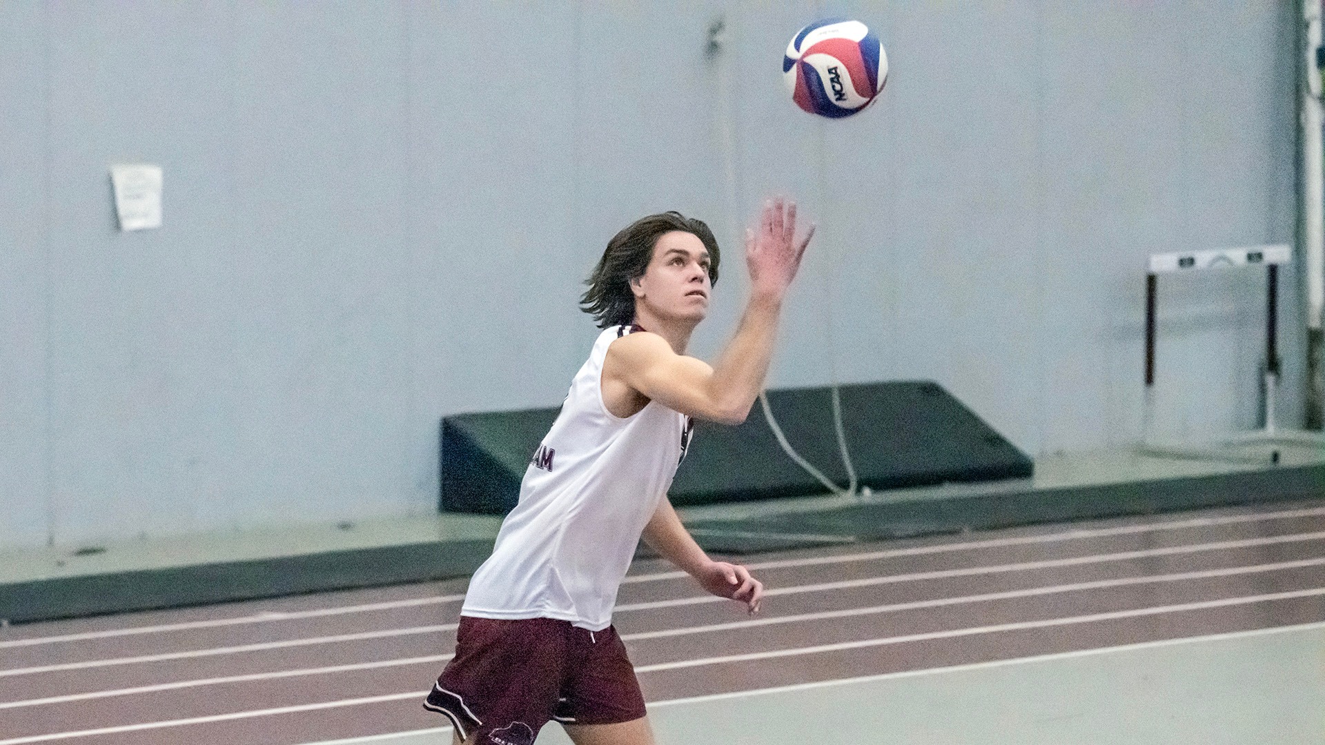 Duncan Tenhagen serves against Endicott College on 3/14/25.