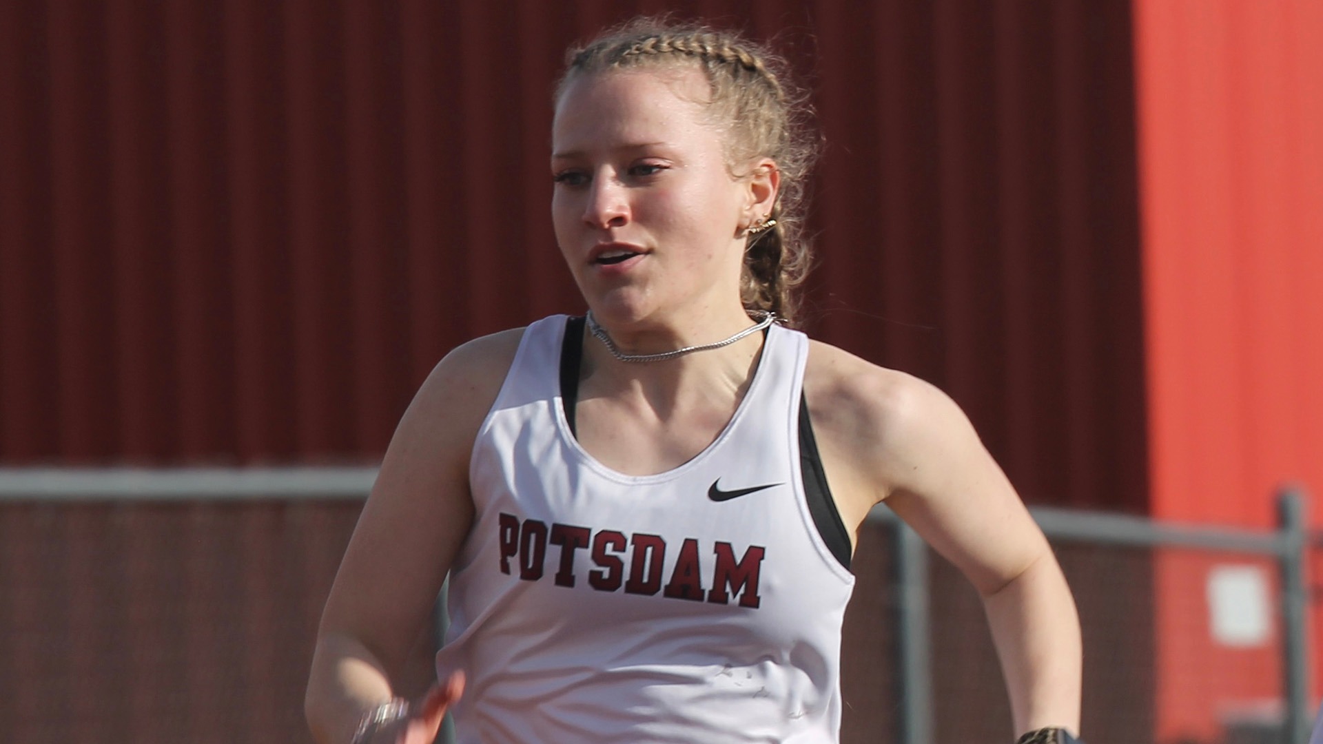 Emily Yousey runs at Cortland on 4/4/25.