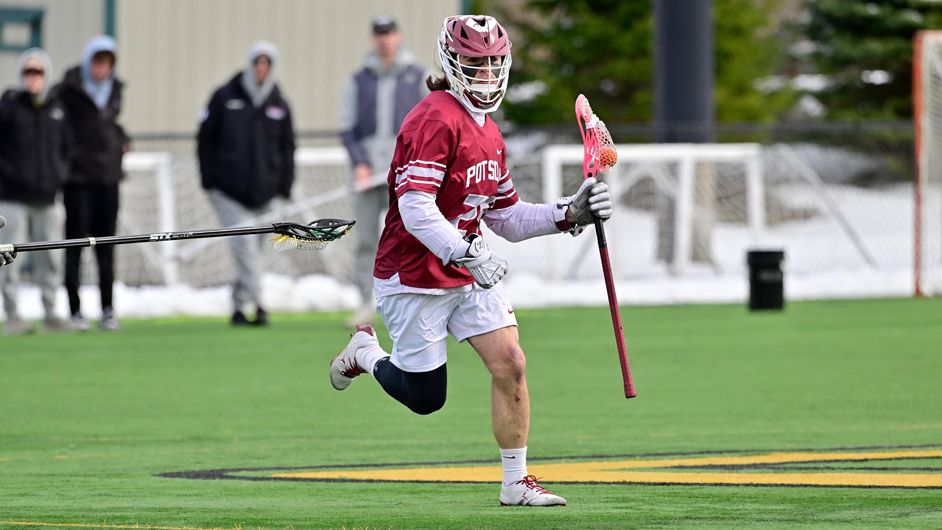 Billy Kozloski carries the ball against Clarkson on 3/24/26.