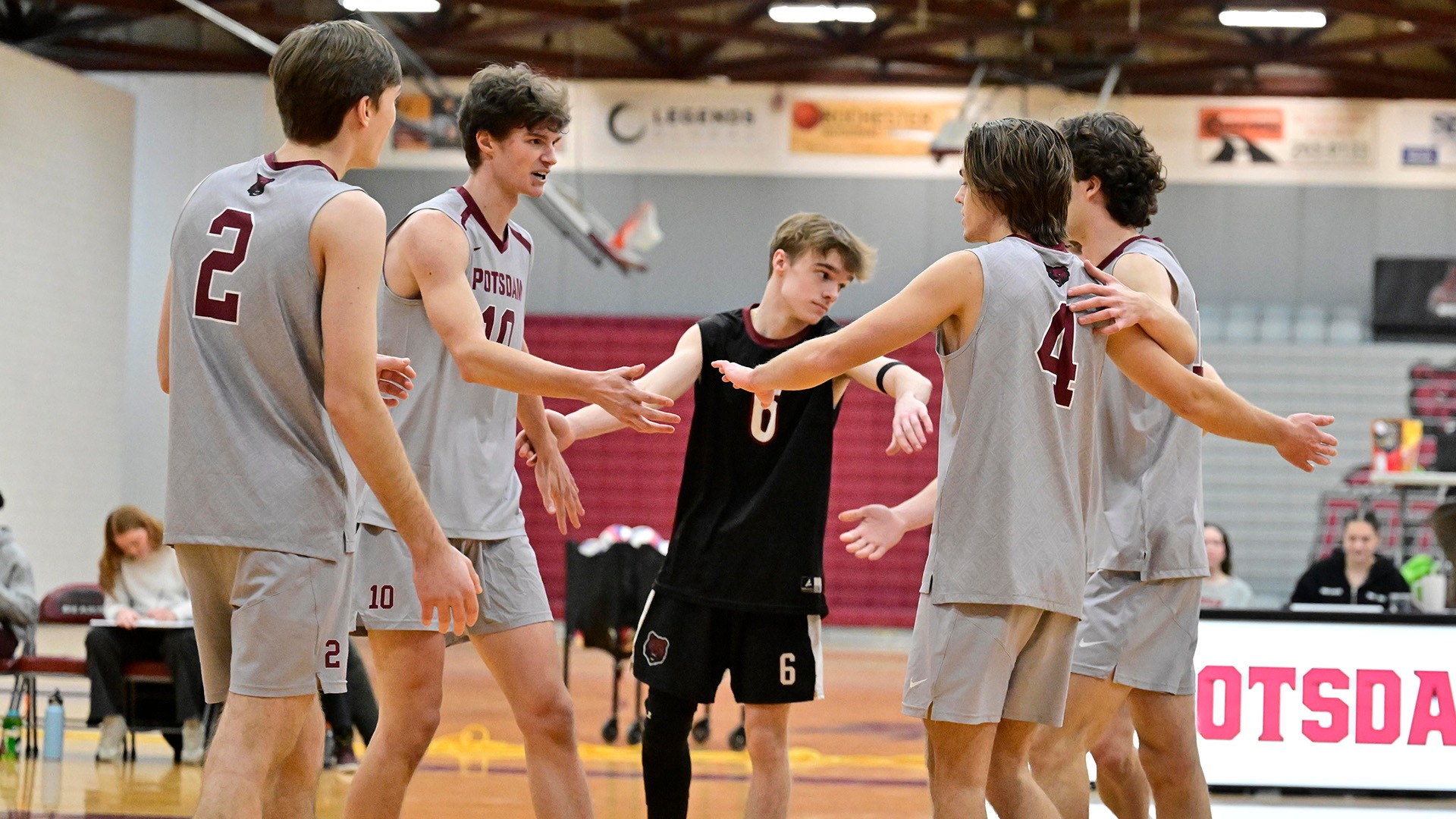 The SUNY Potsdam Men's Volleyball Team huddles before the start of a February 7, 2026 match with Bard College.
