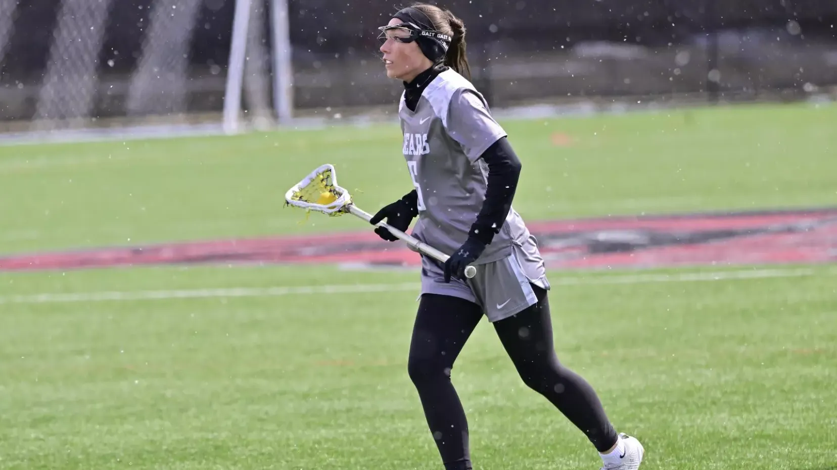 Megan MacWilliams carries the ball against Oneonta on March 28, 2026. 