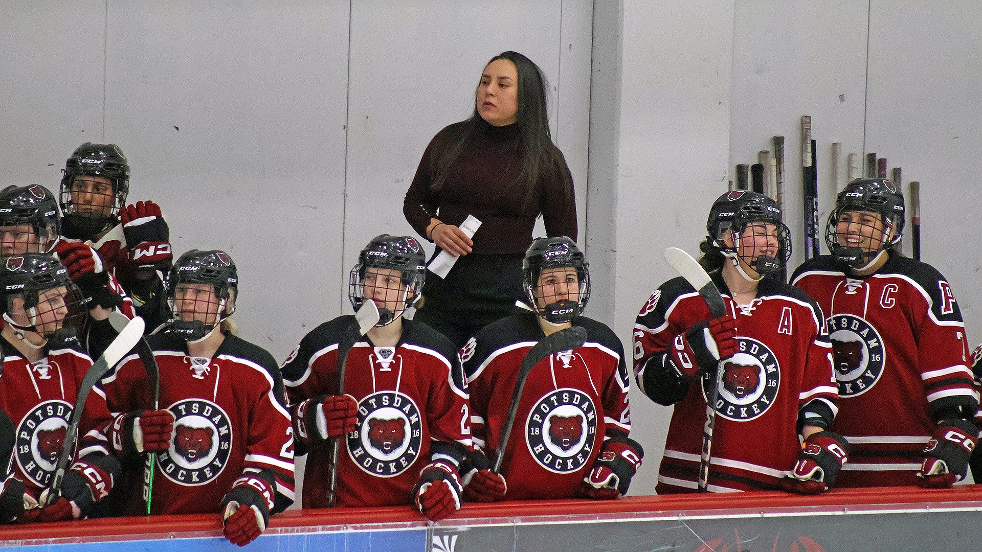 Olivia Cook coaches during the 2025-26 season.