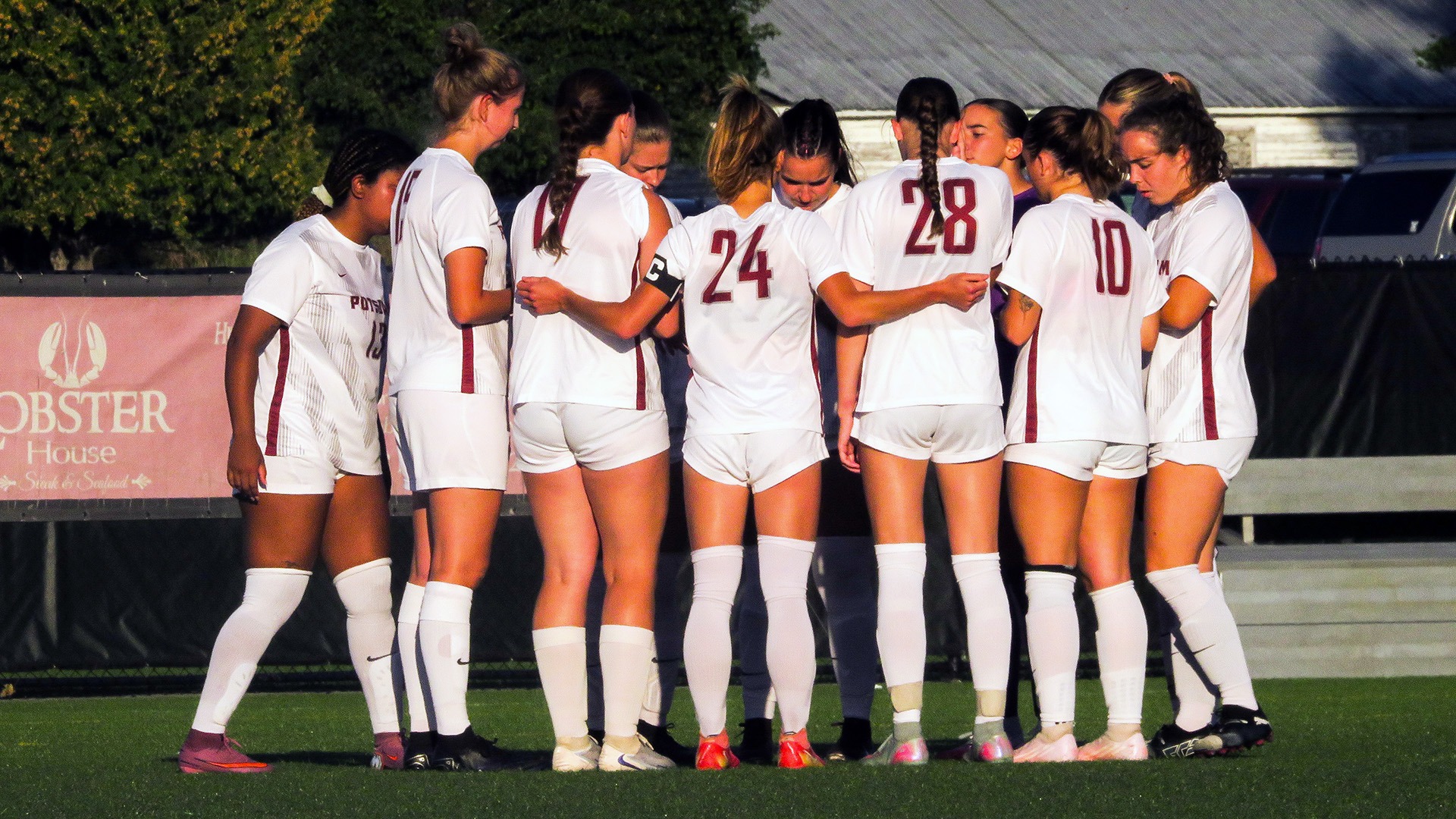The women's soccer team huddles during game with Utica on 9/4/26.