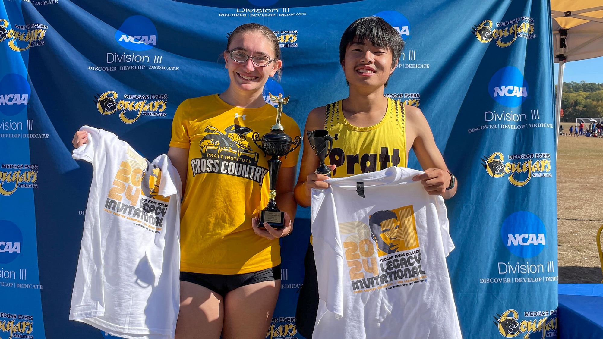 Giovanna Lisa and Justin Cai hold their individual champion trophies after winning the Medgar Evers Legacy Invitational.