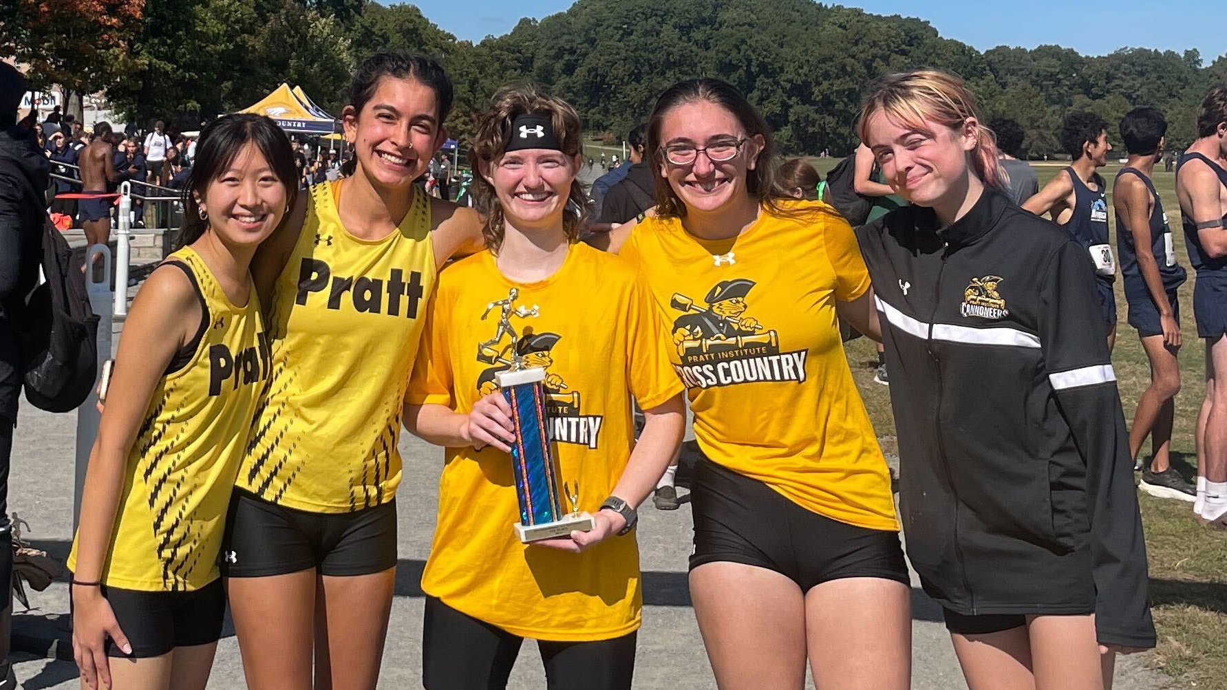 Women's Cross Country holding the team trophy after winning the Queensborough CC Invitational