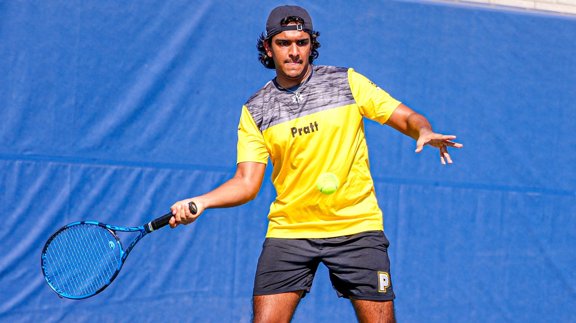 Zuhayr Abdulla returns a serve with a right-handed forehand