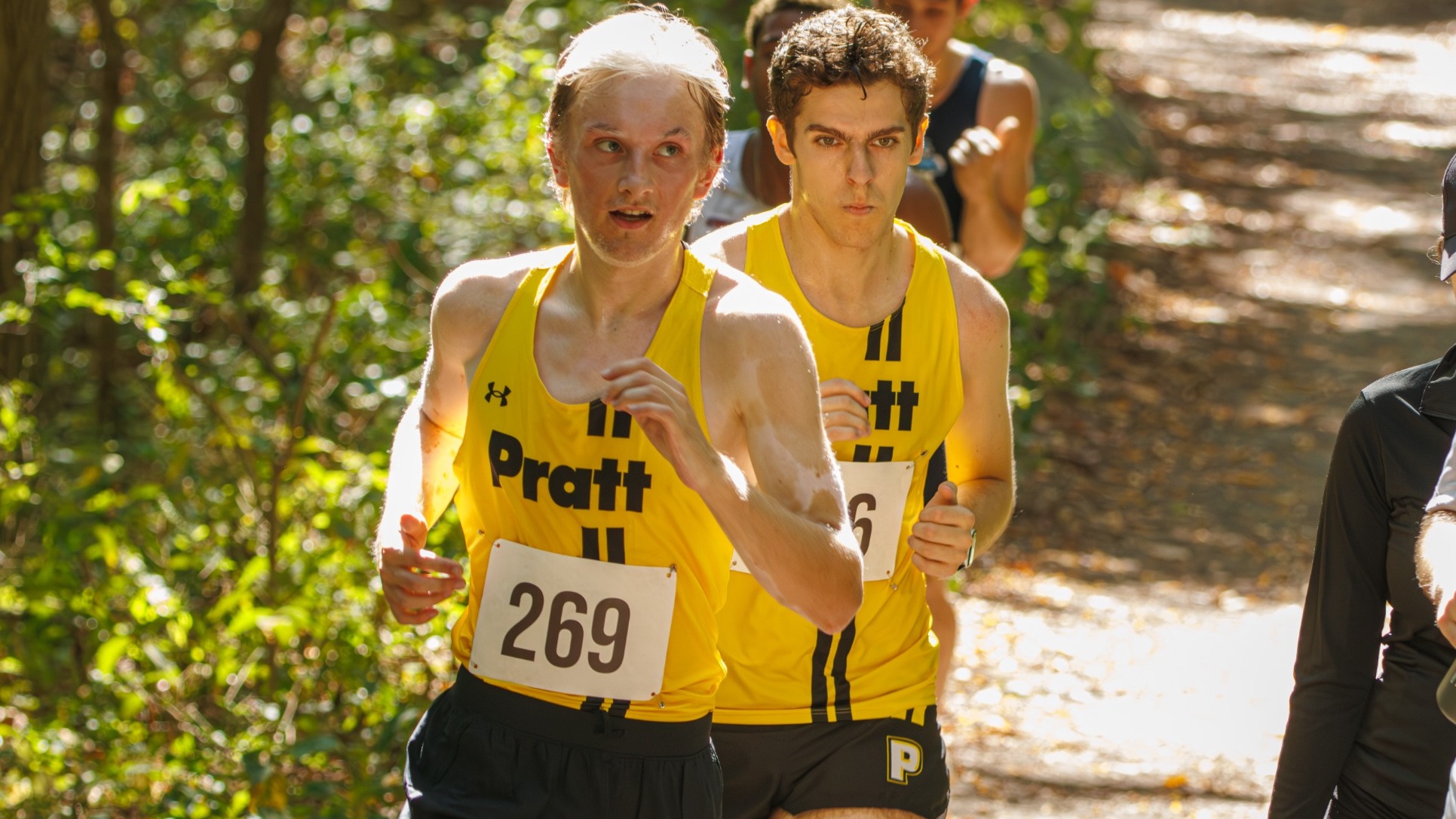Liam Reilly and Jackson Brock run in the back woods of Van Cortlandt Park