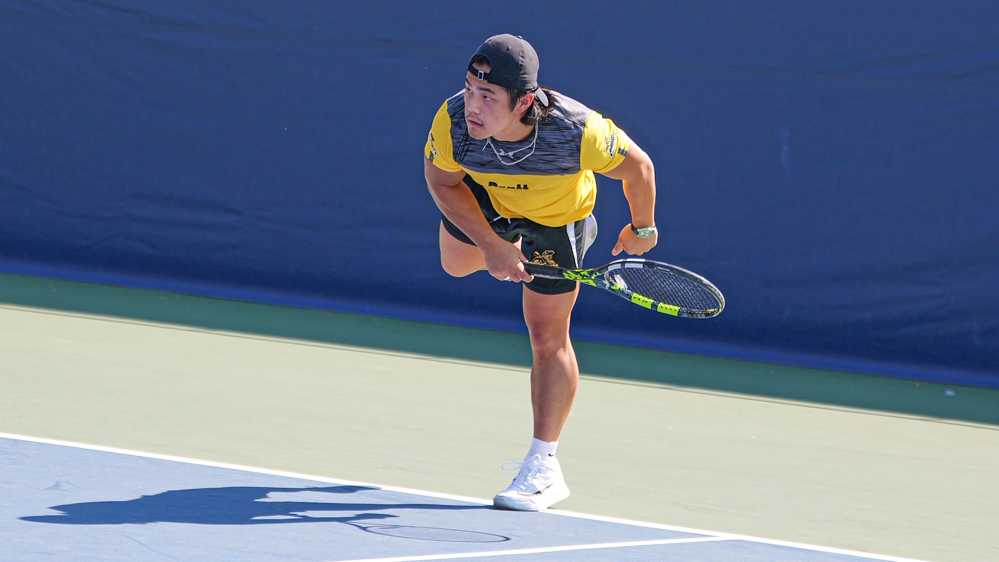 Mikah Liu follows through after serving to the ad court.