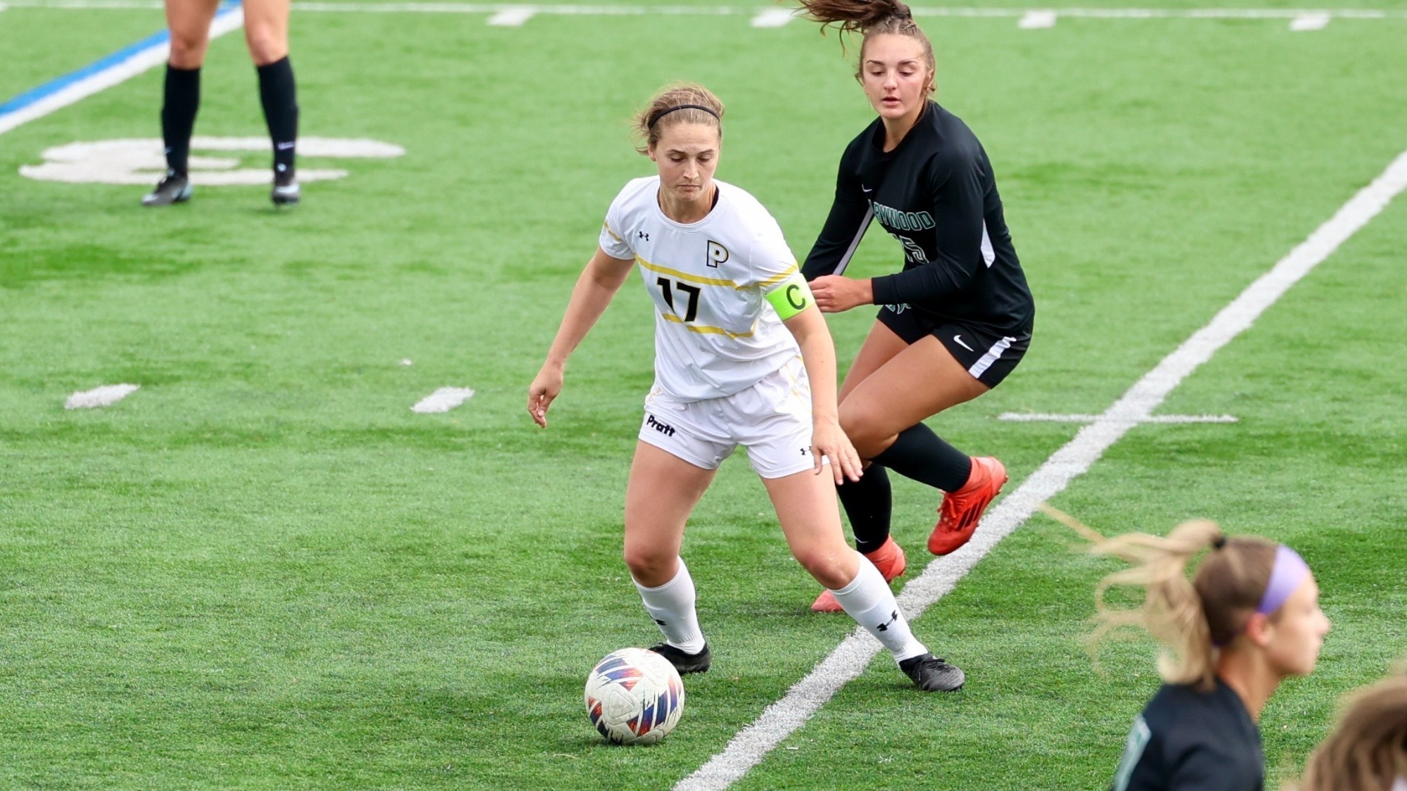 Kat Thomsen plays the ball at her feet in the midfield