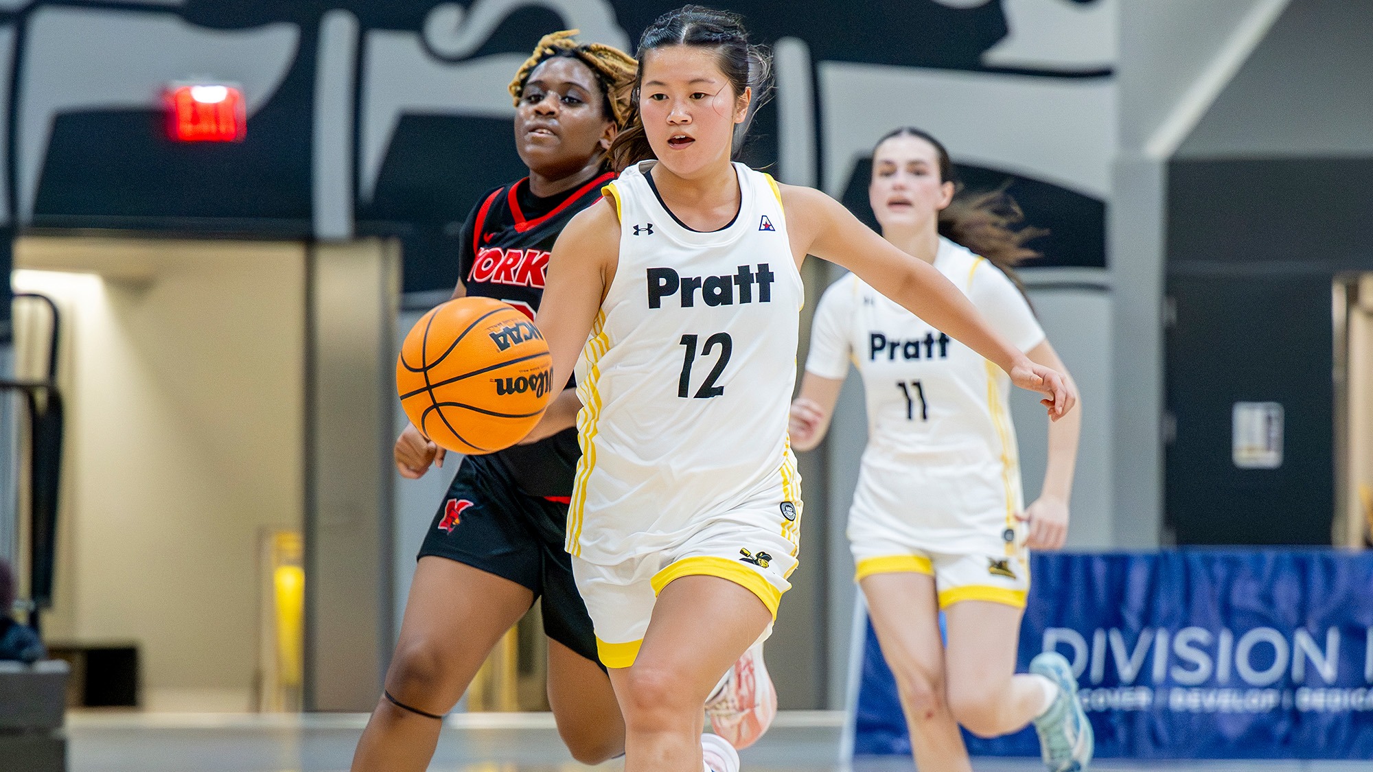 Miga Higa dribbles away from a York defender.