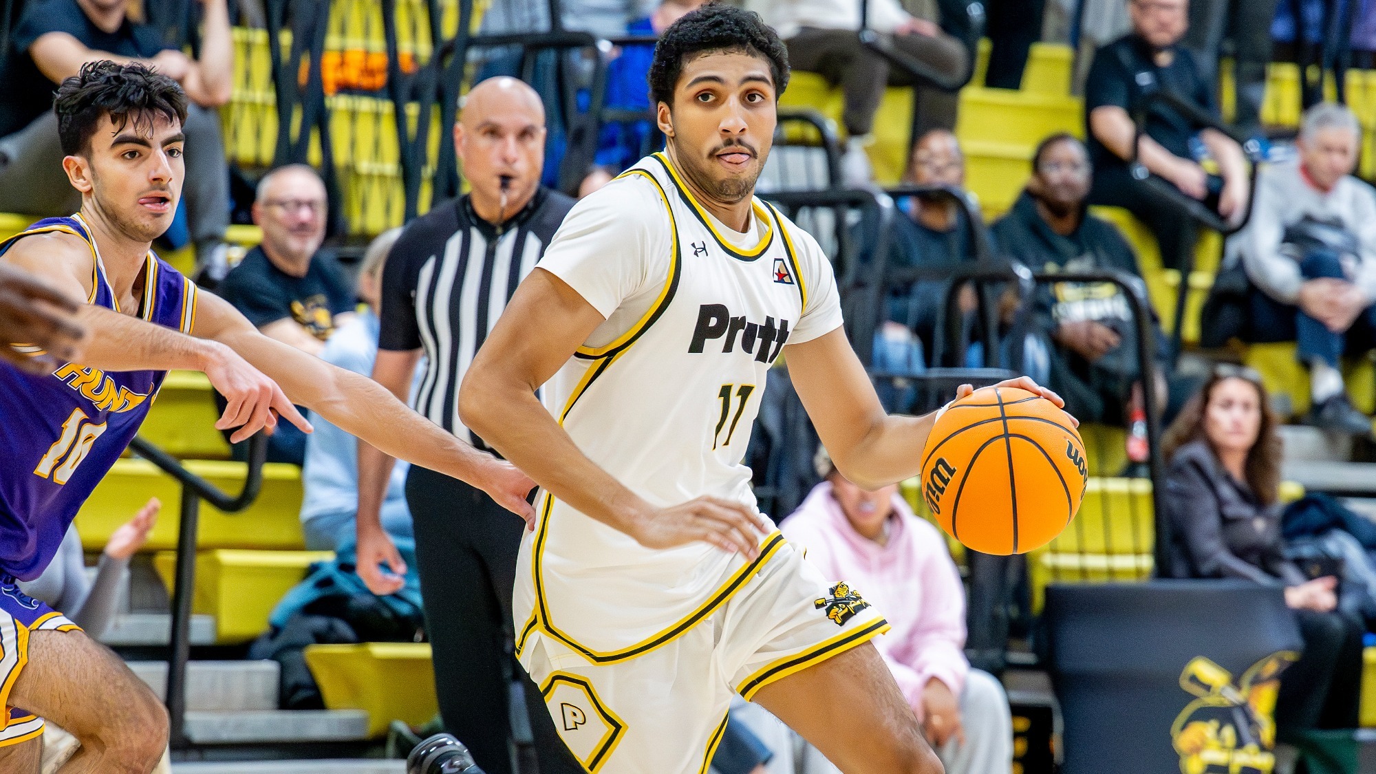 Trey Phillips dribbles left-handed past a Hunter defender