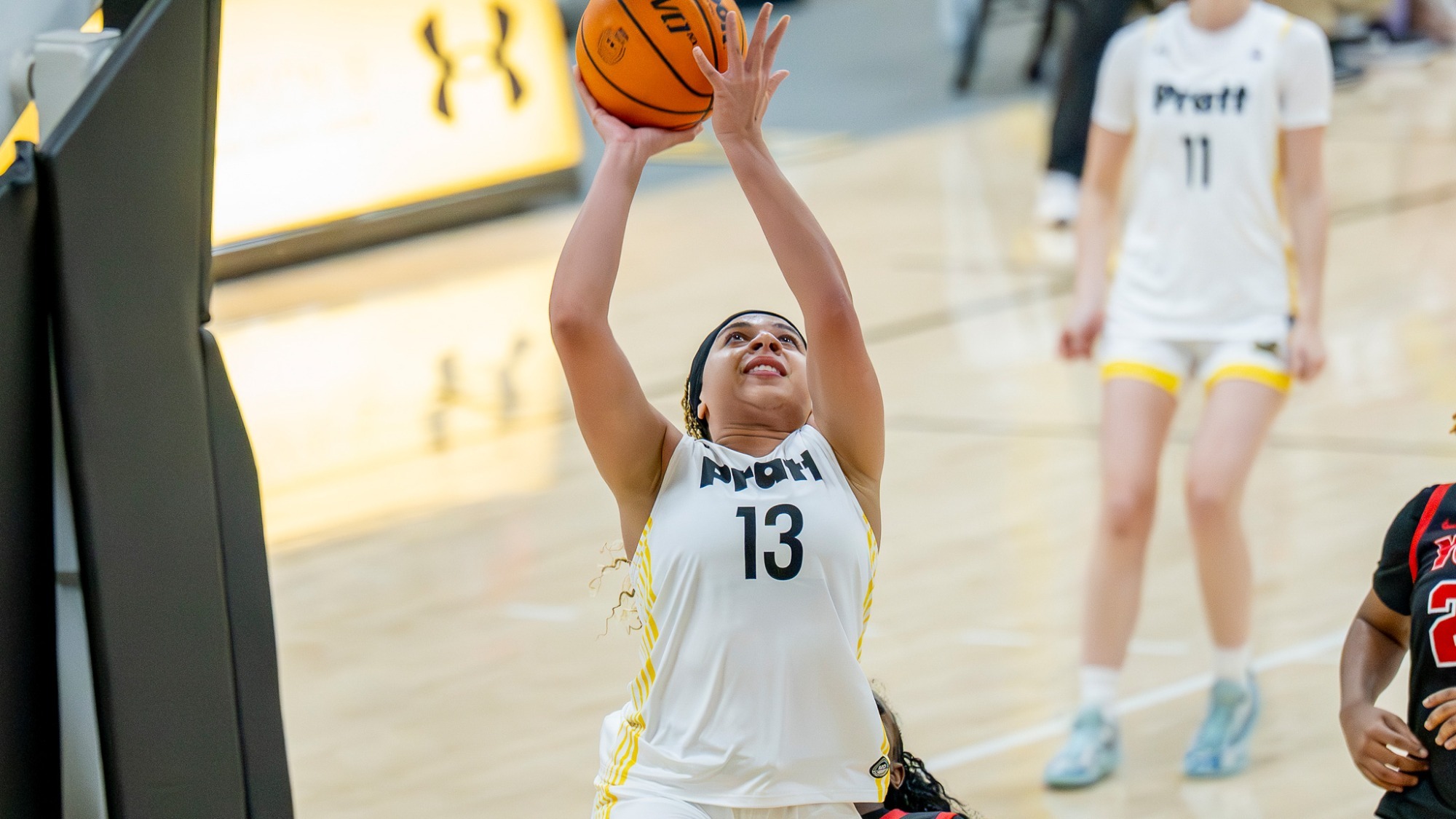 Kylie Grant shoots a layup from underneath the basket
