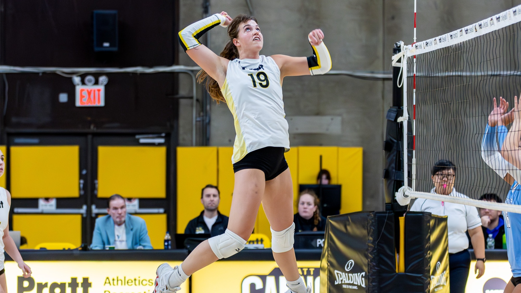 Colleen Russell jumps up for a spike near the net.
