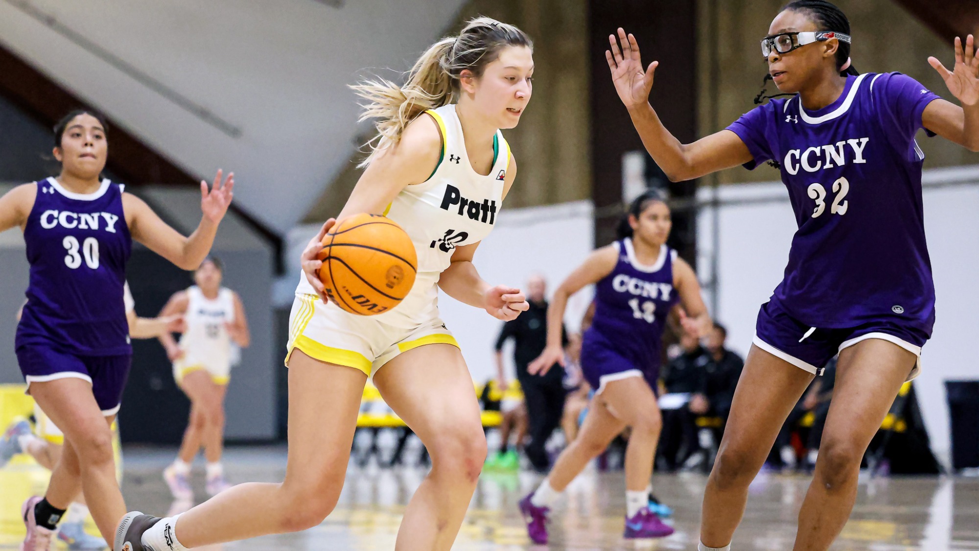 Anabela Jakelic dribble drives with her right hand against a CCNY defender.