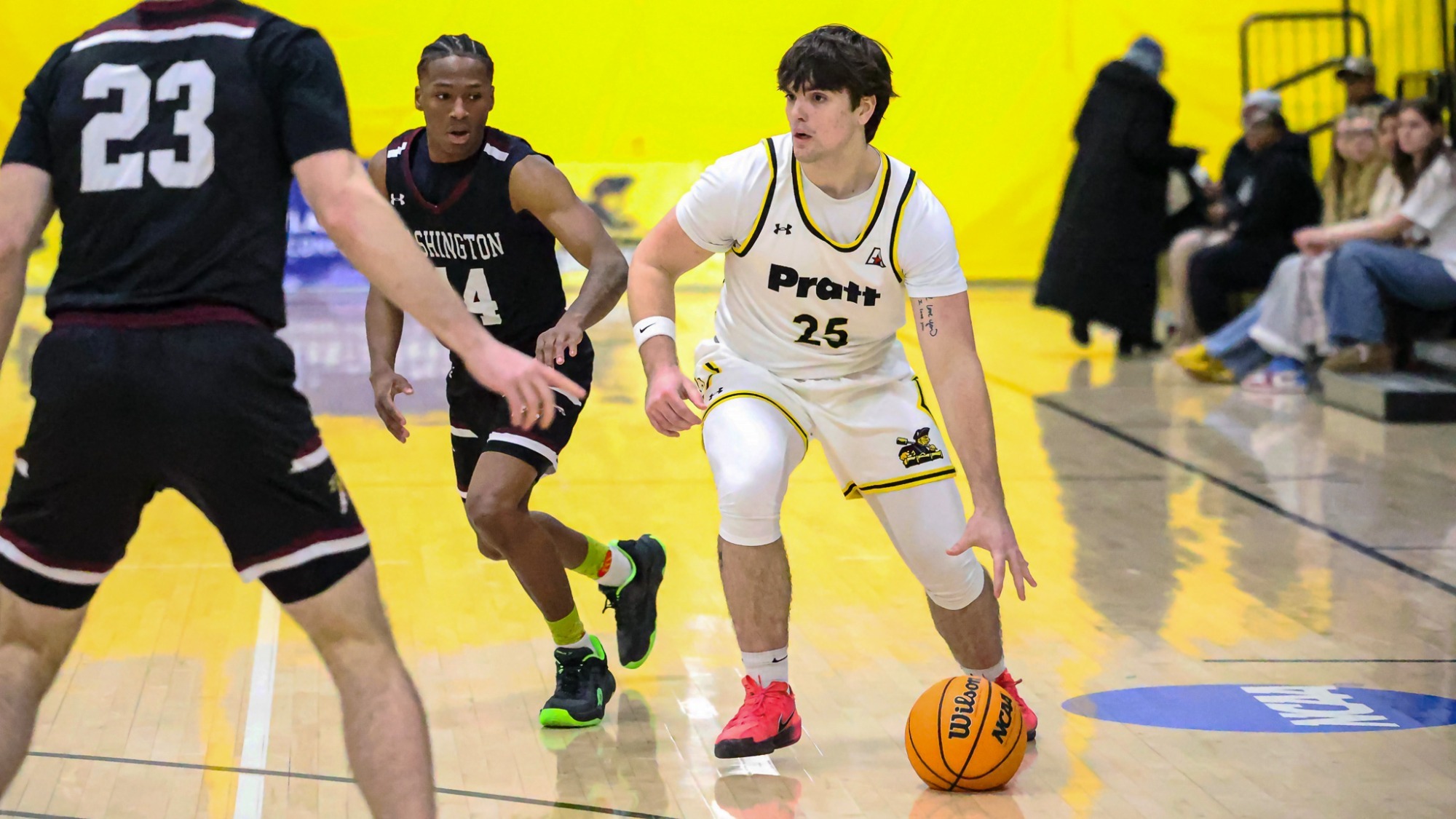 Mason Fritz dribbles with his left hand surrounded by Washington defenders