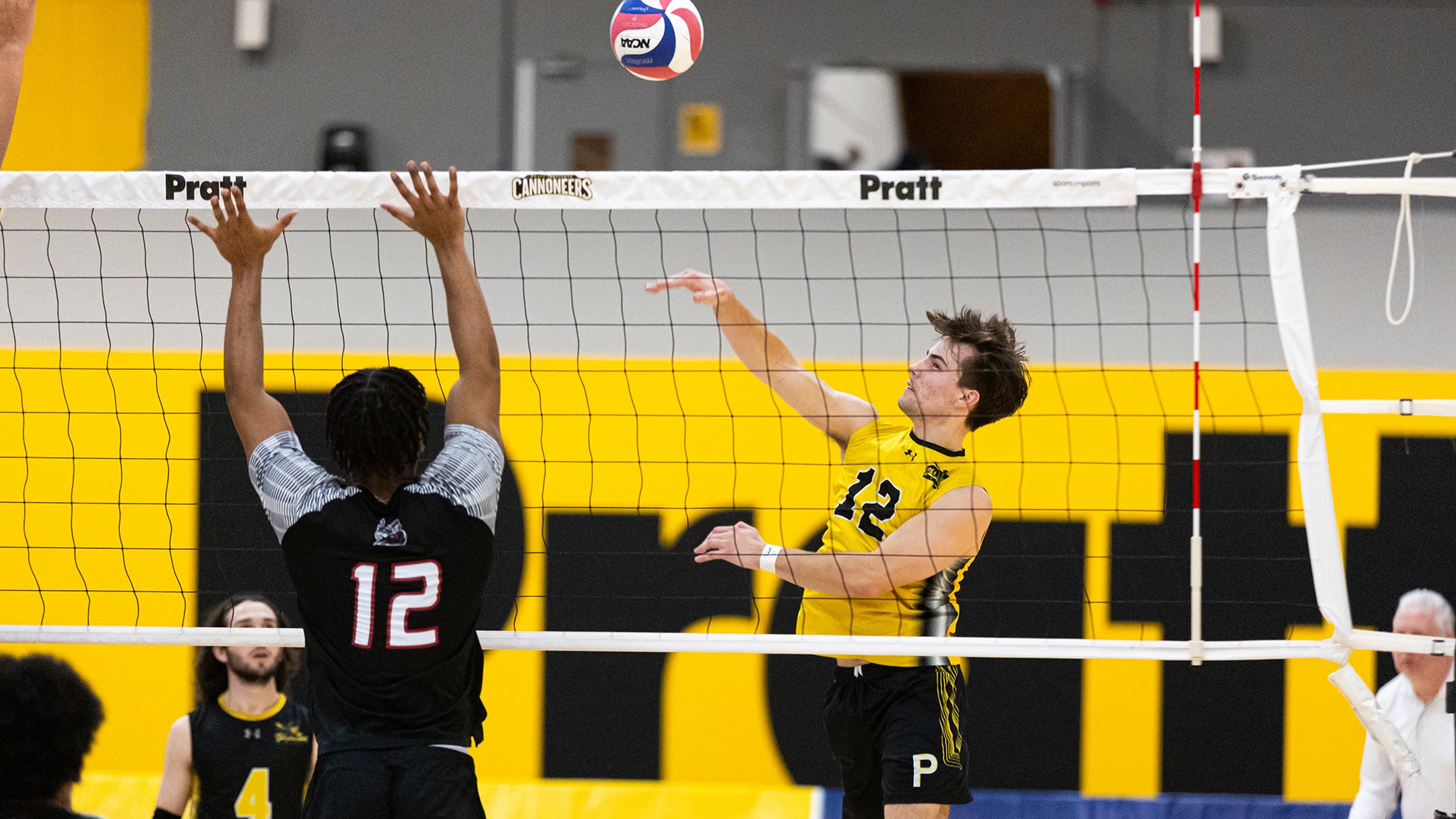 Griffin Benkovszky spikes a ball against Manhattanville