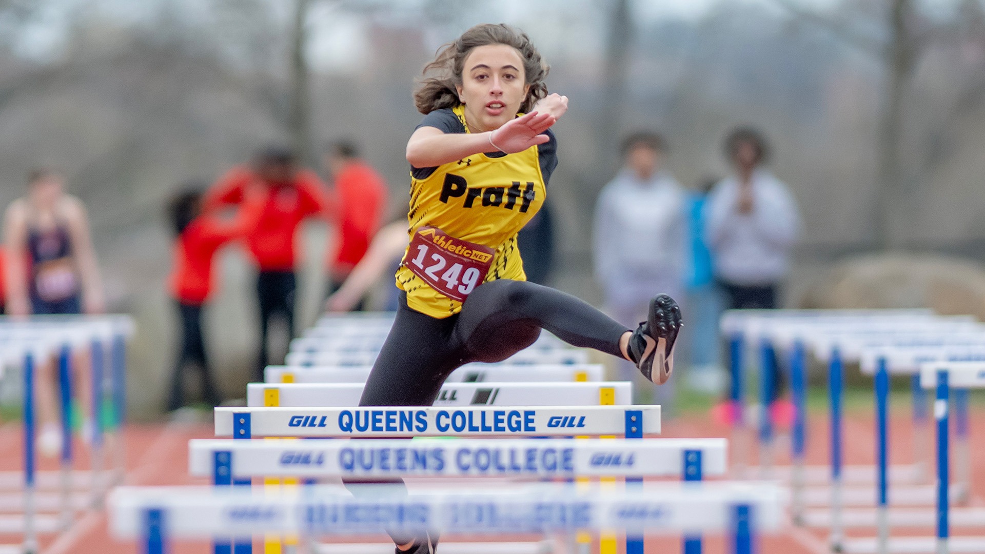 Brooke Schreffler jumps over a hurdle