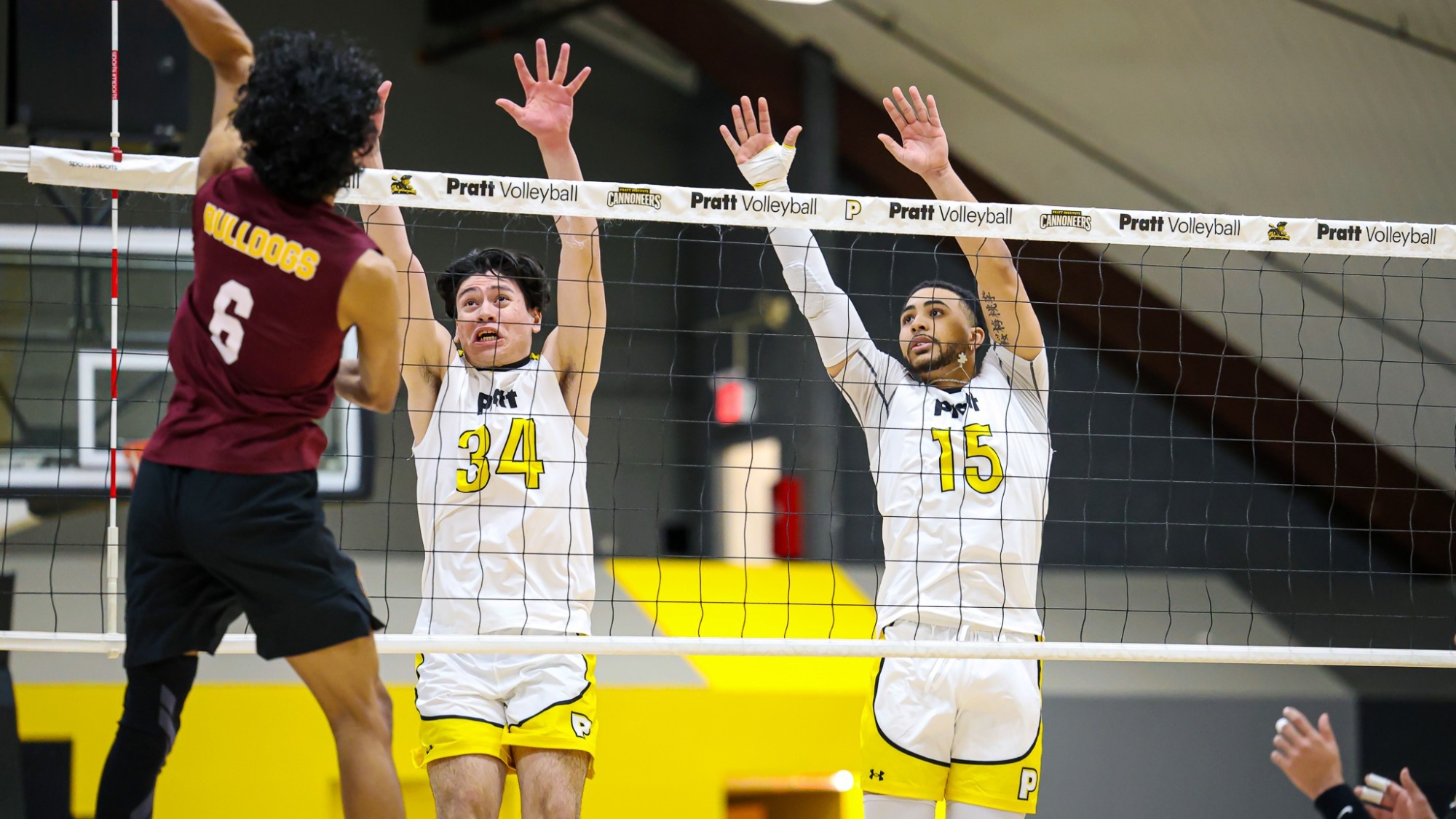 Arturo Mata (34) and Micah-Jude Upshaw (15) at the net attempting to block a Brooklyn attacker.