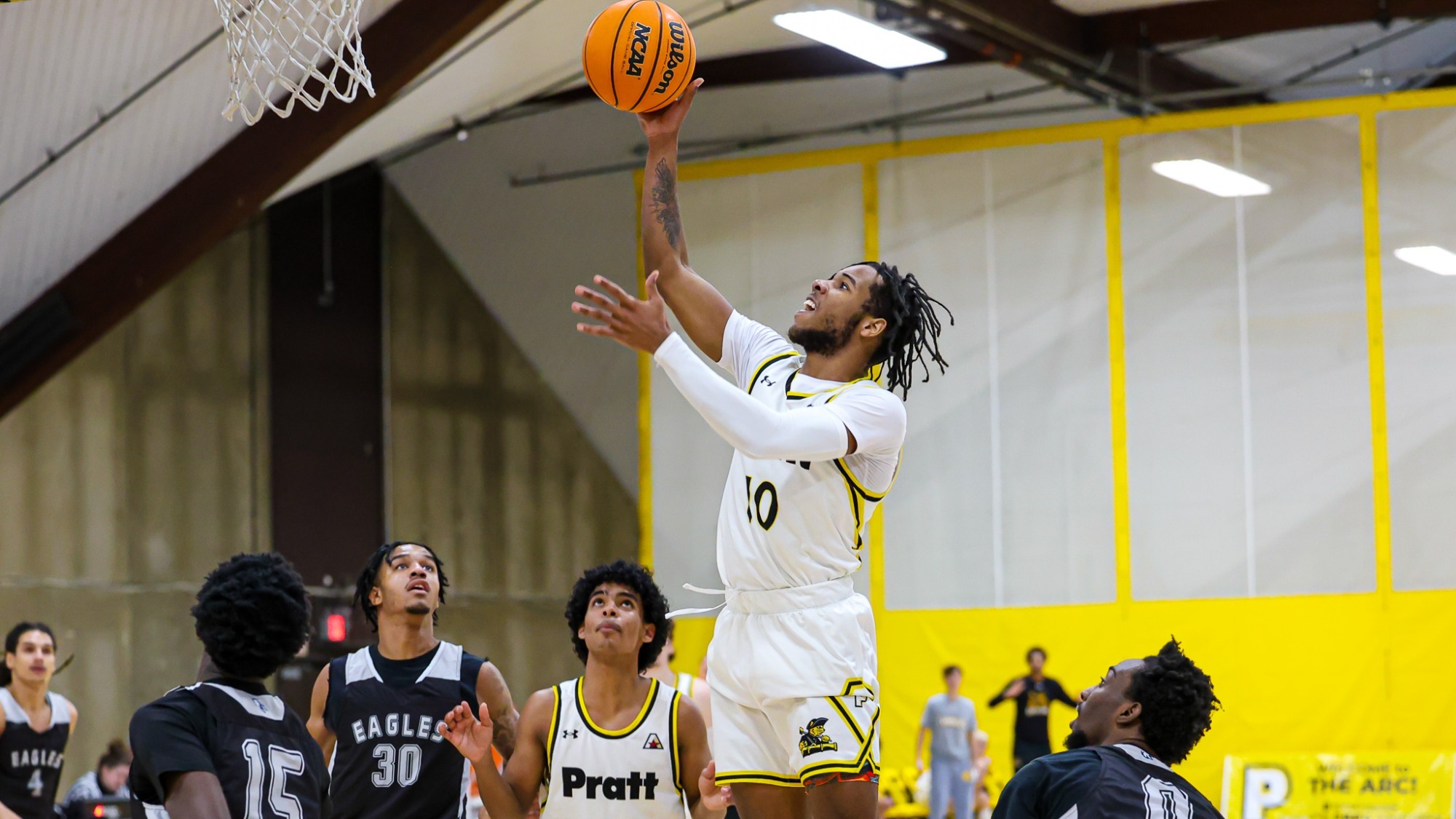 Mekhi Davis rise above several defenders in the paint for a layup.