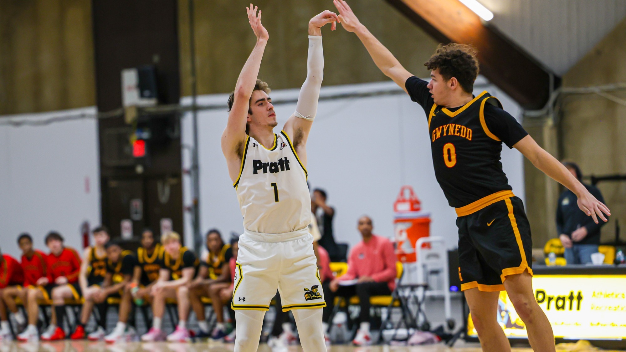 Thomas Graetz shoots a three-pointer over a Gwynedd Mercy defender with a hand in his face