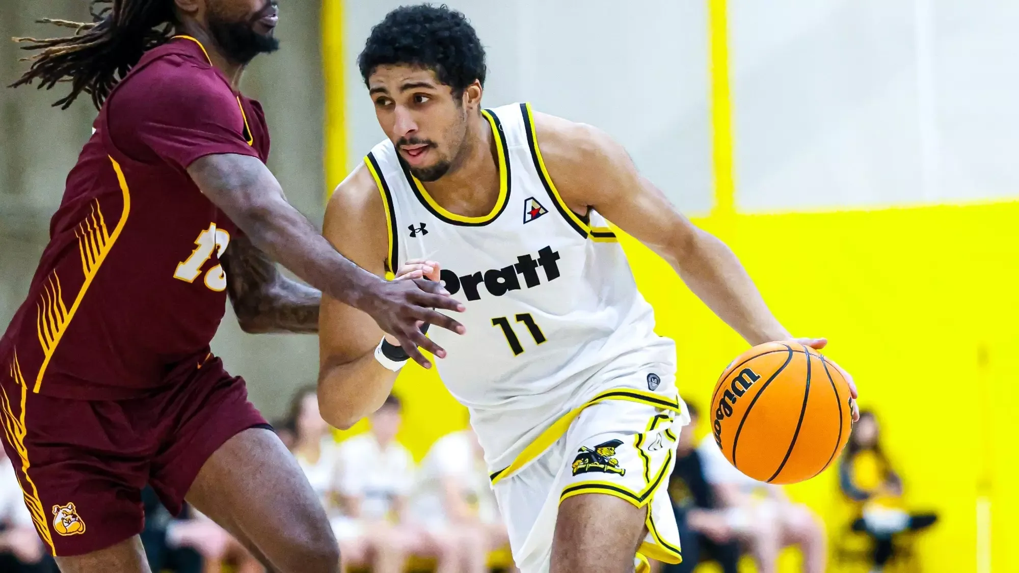 Trey Phillips drives to the basket with his left hand