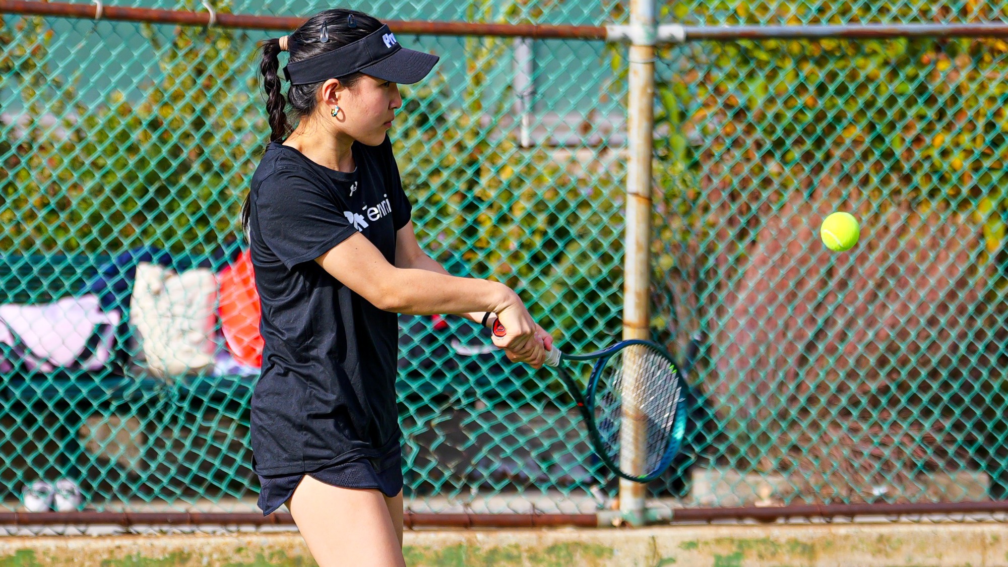 Judy Song hits a two-handed backhand