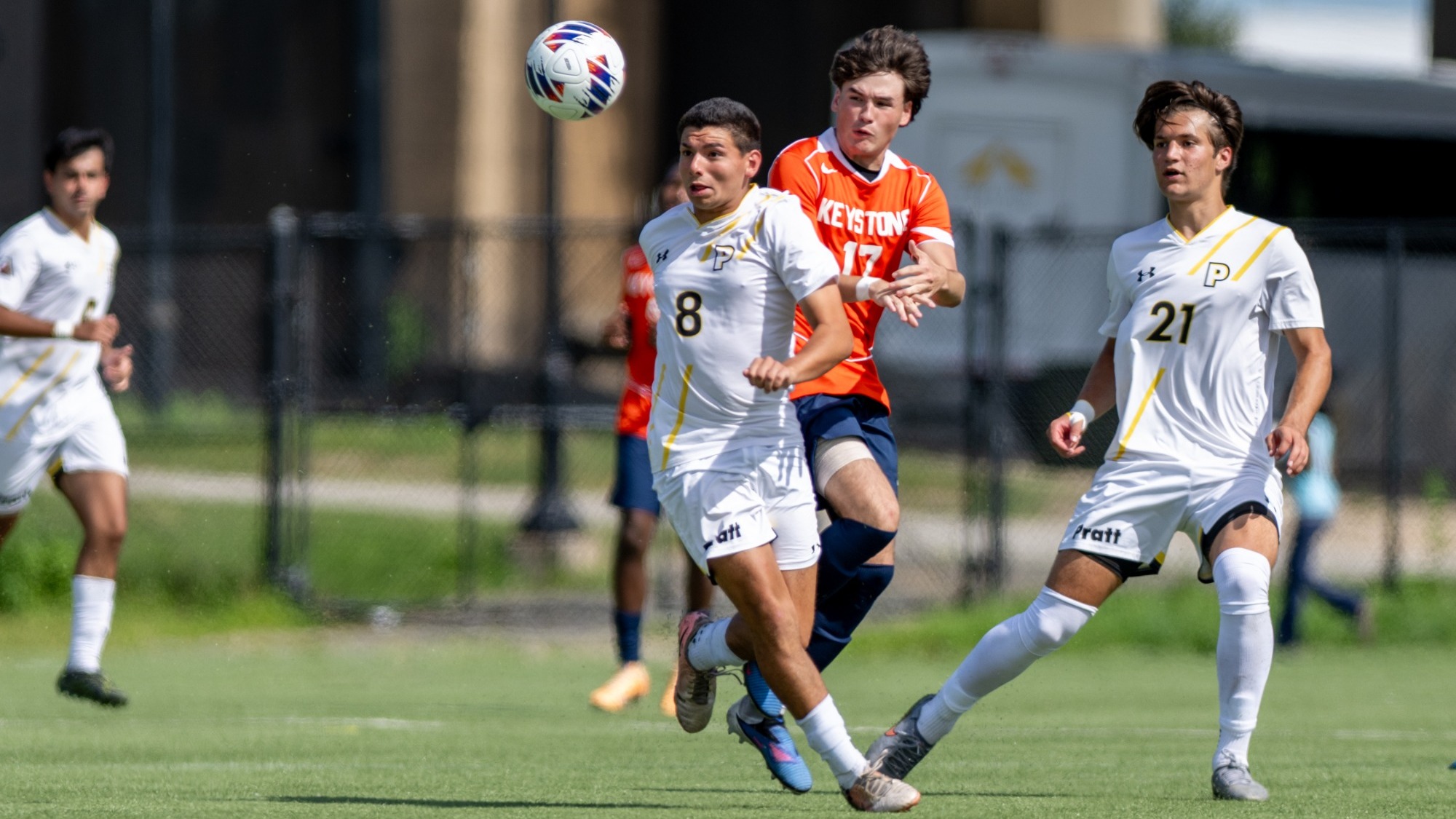 Nicco Prada tries to play a high ball shielding off an opposing Keystone player