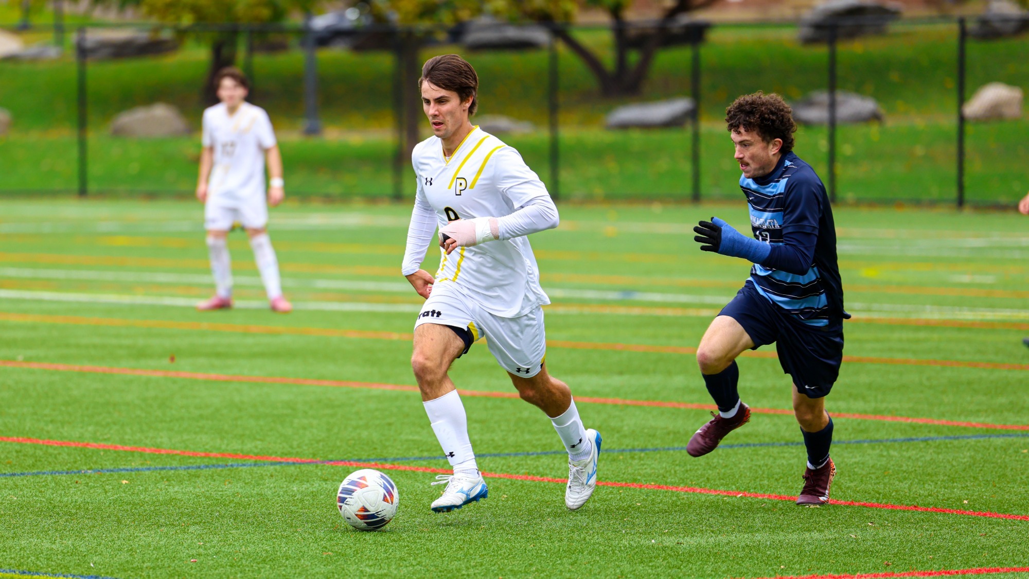 Griffin Benkovszky dribbles away from an Immaculata defender.