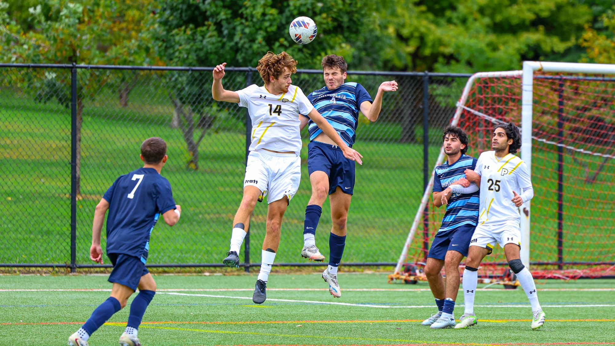 Pavel Emam jumps up with an Immaculata defender trying to head a ball in the box 