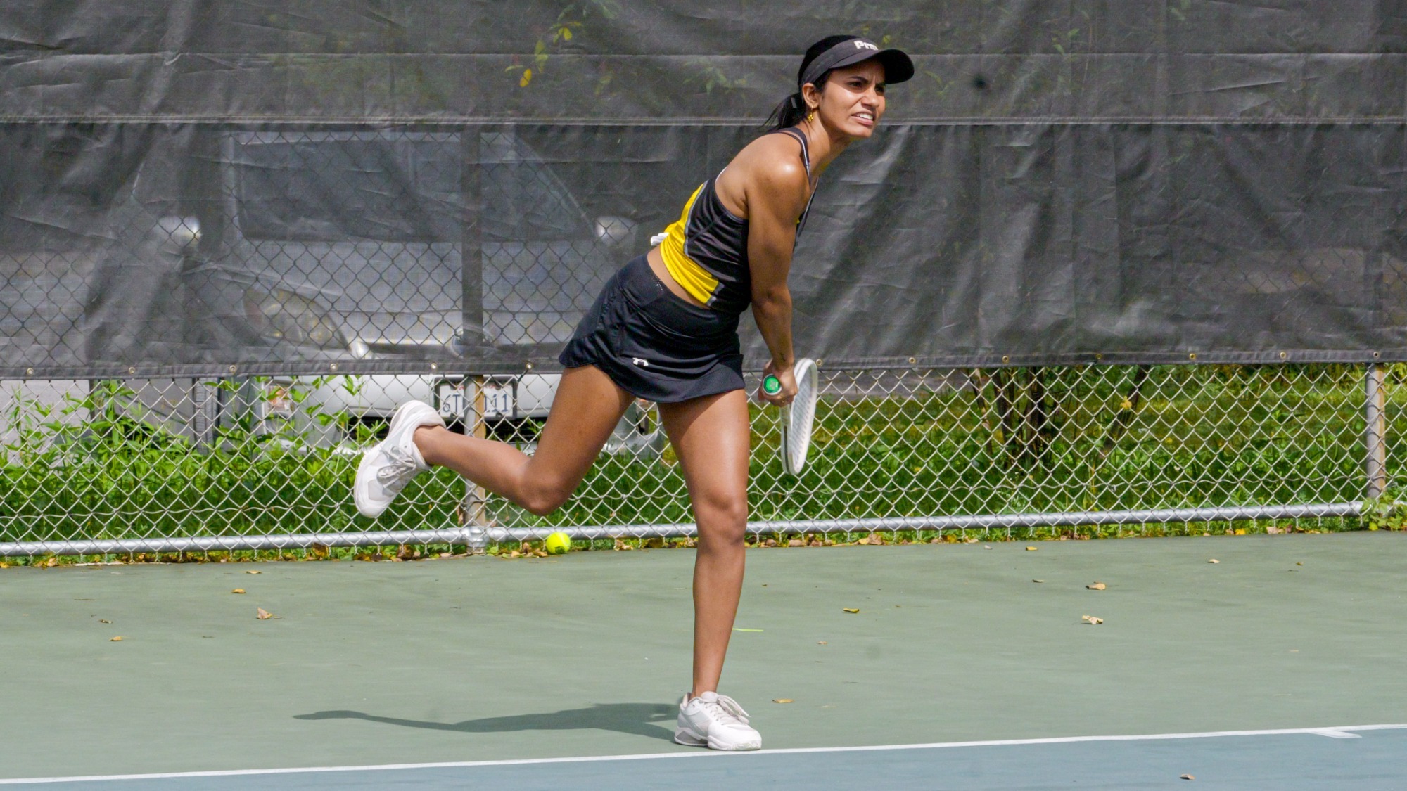 Pallavi Verghese follows through after her serve