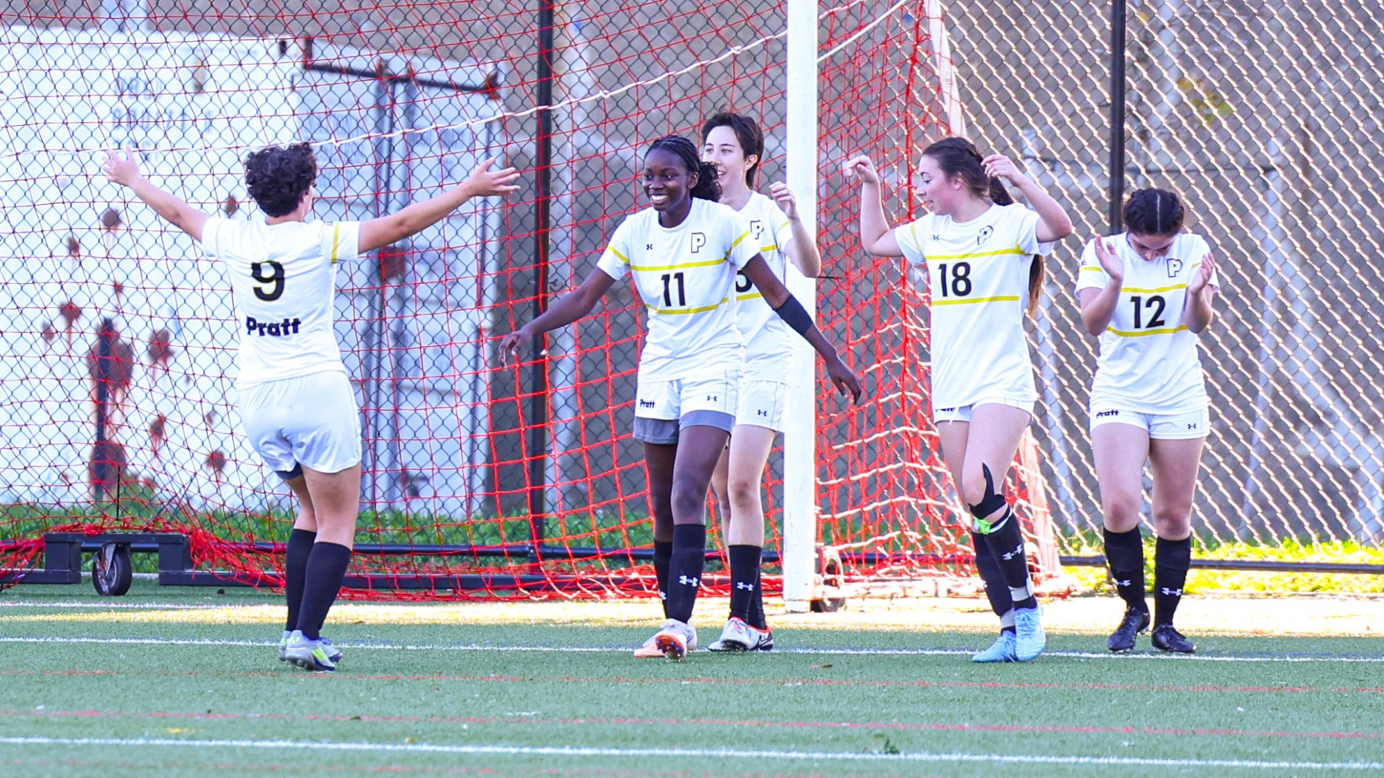 Kemi Ayeni and team celebrate after a goal.