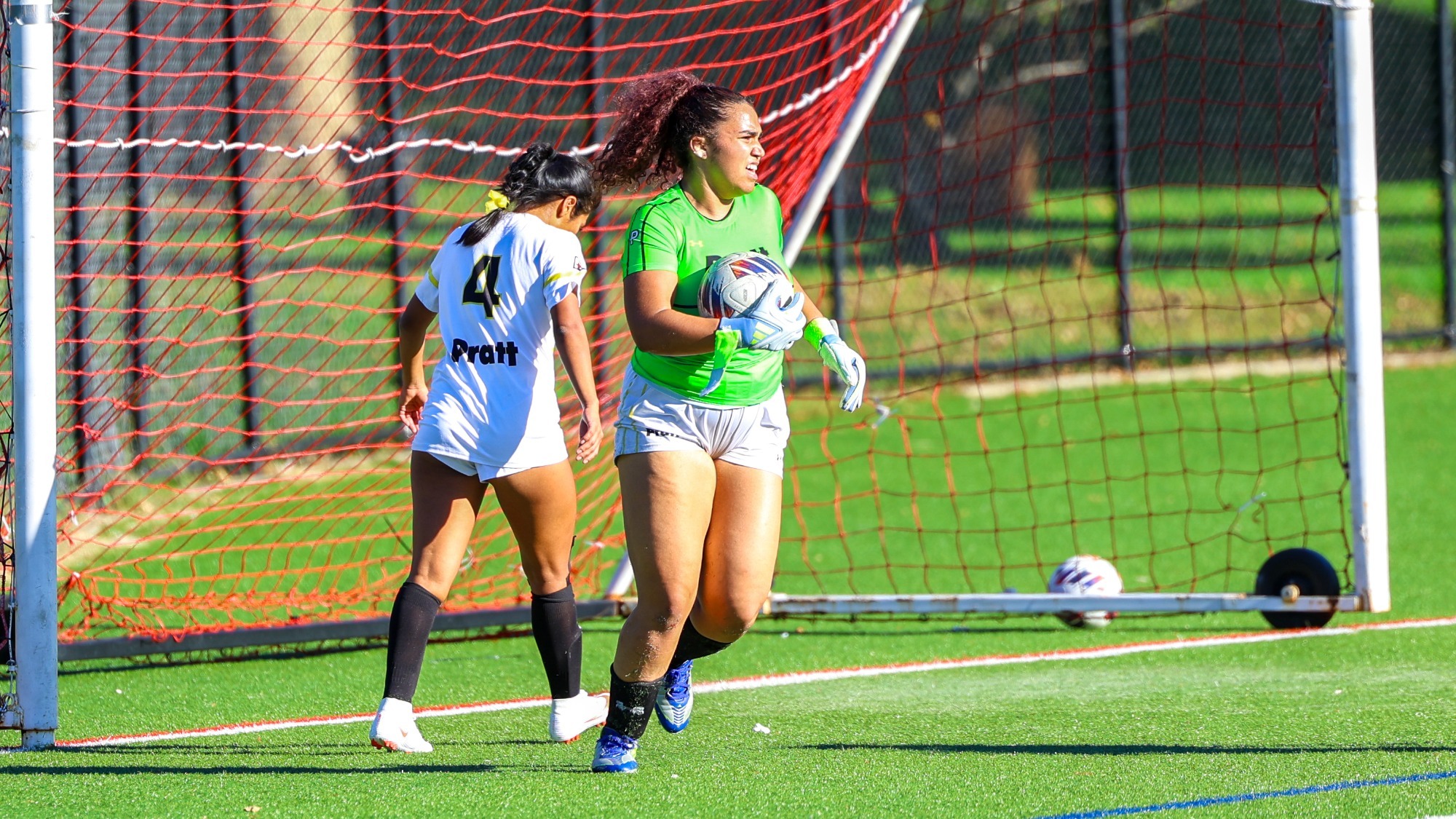 Angelina Perez holds the ball in front of goal looking to pass.