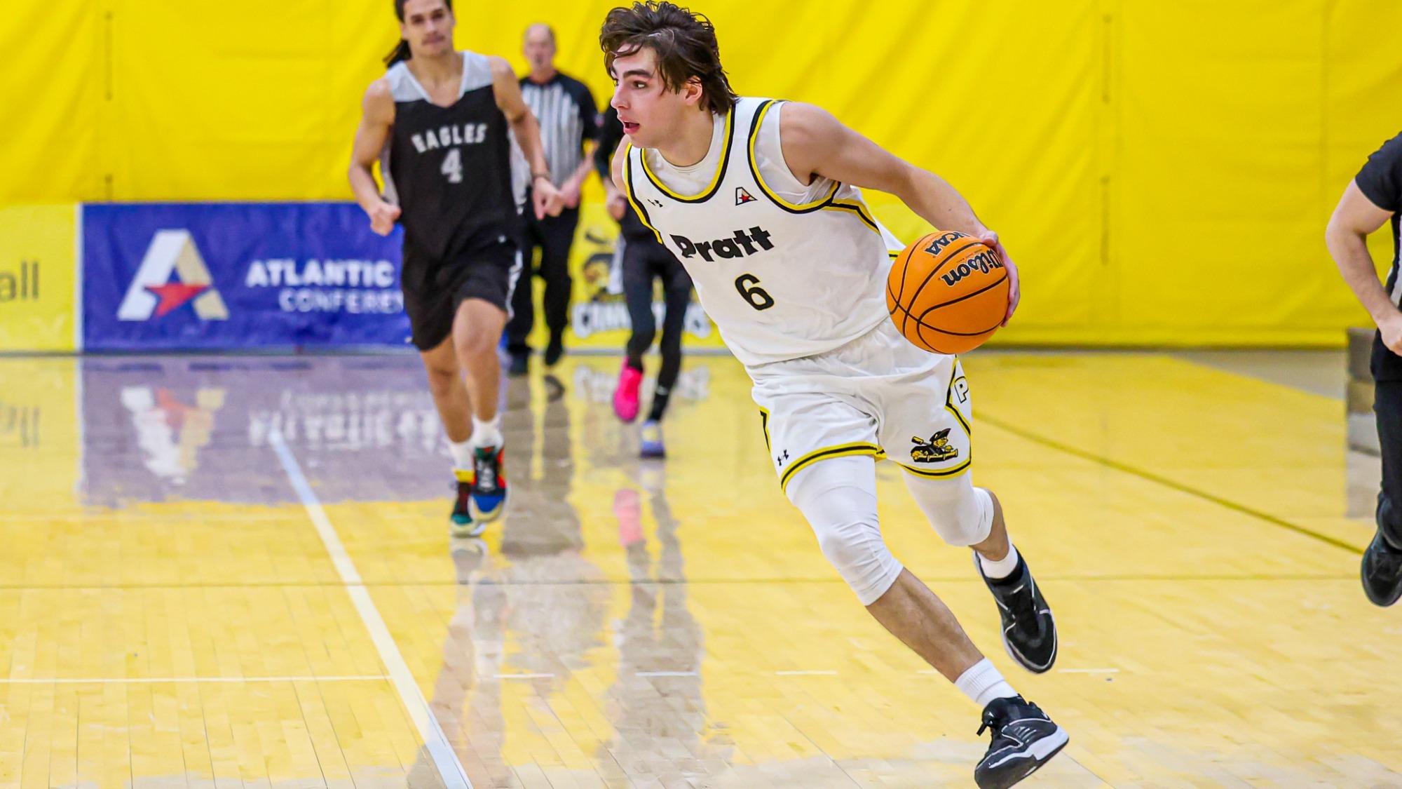 Thomas Prendergast dribbles with his left hand in the open court.