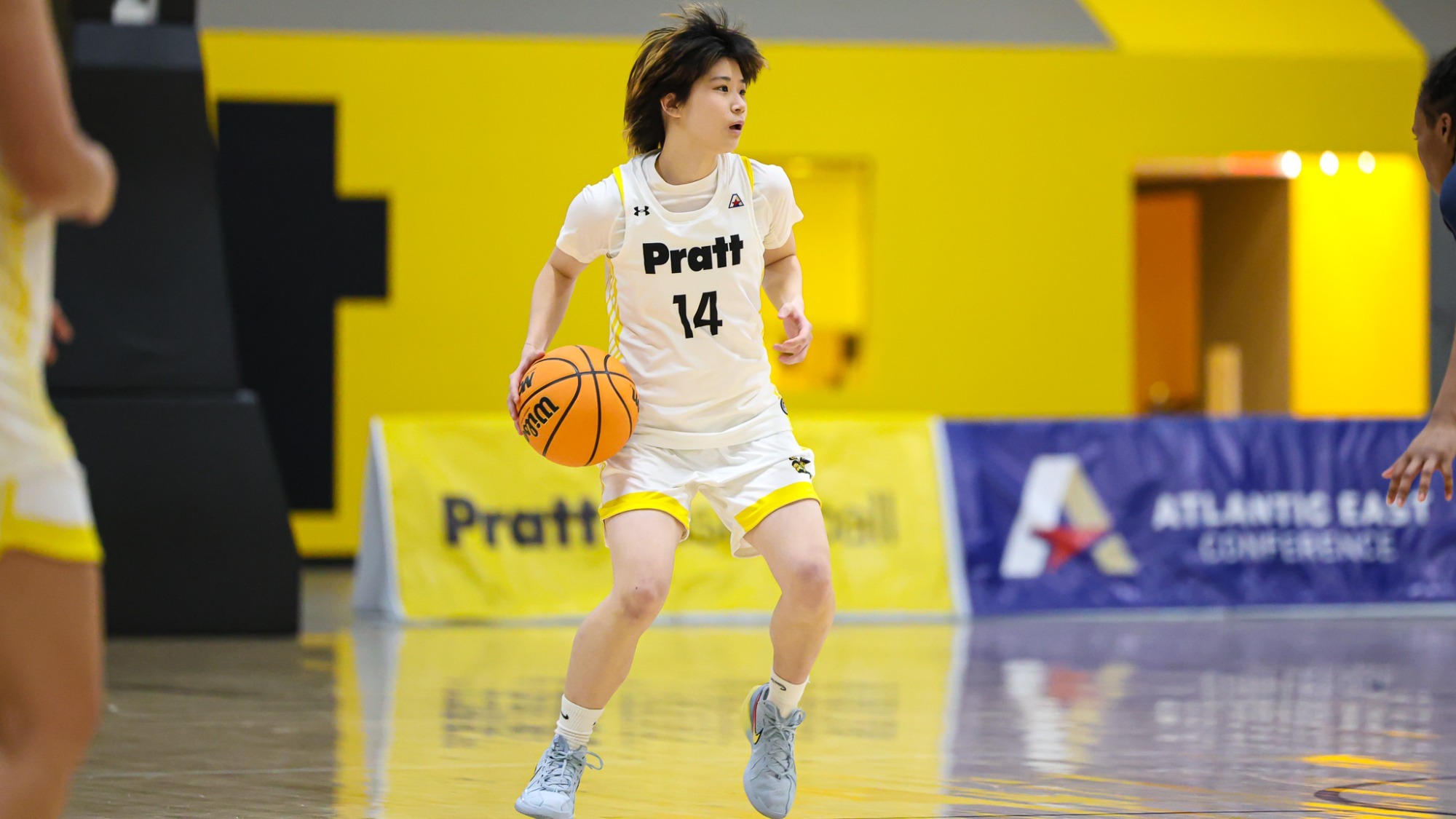 Kaylee Kang dribbles at the top of the arc.