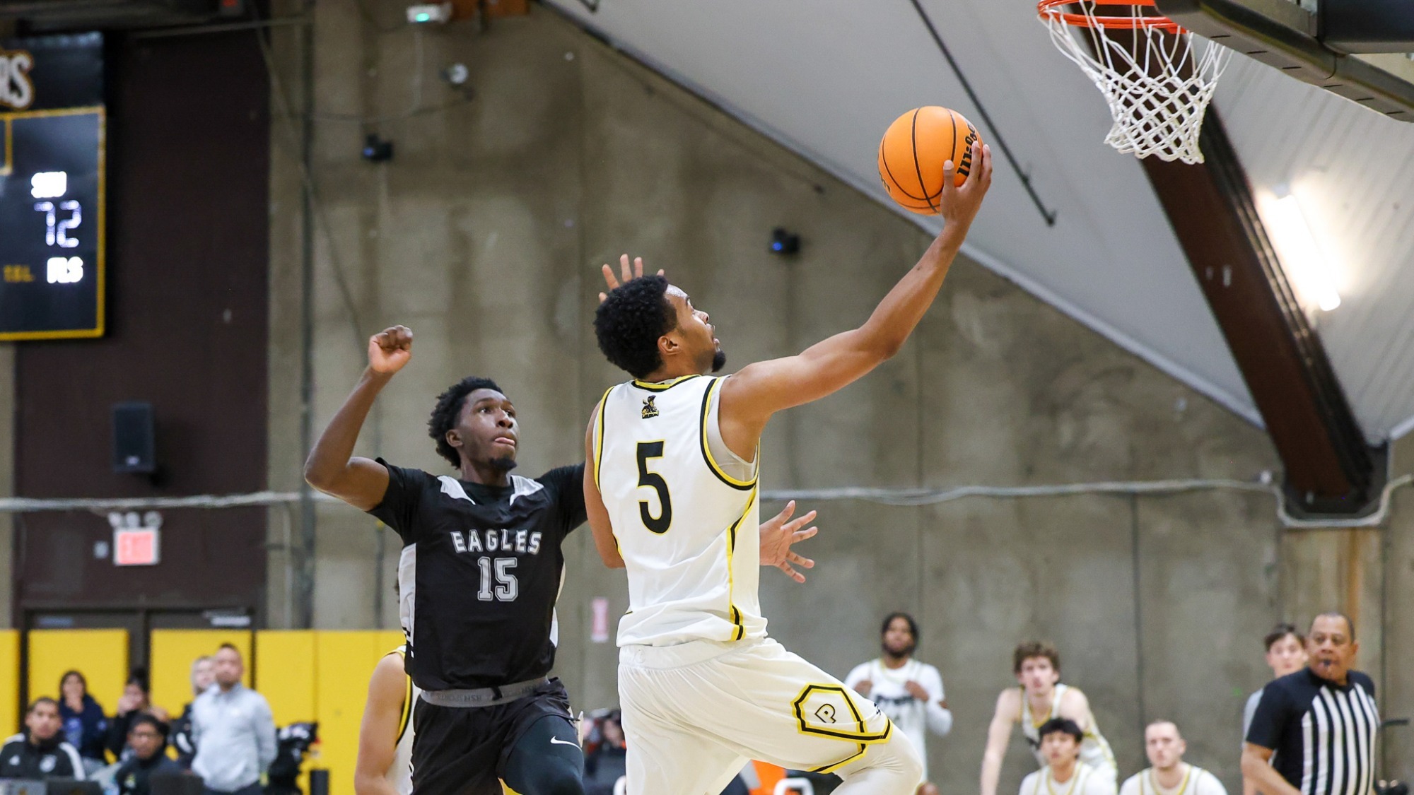 Cam Hatcher drives to the basket for a layup against a St. Elizabeth defender.