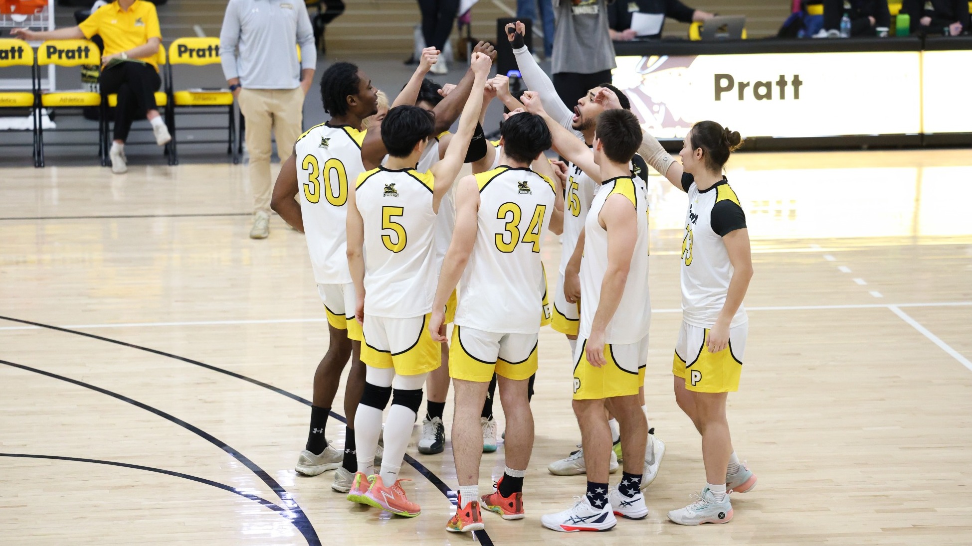 Pratt huddles with their hands up prior to the match.
