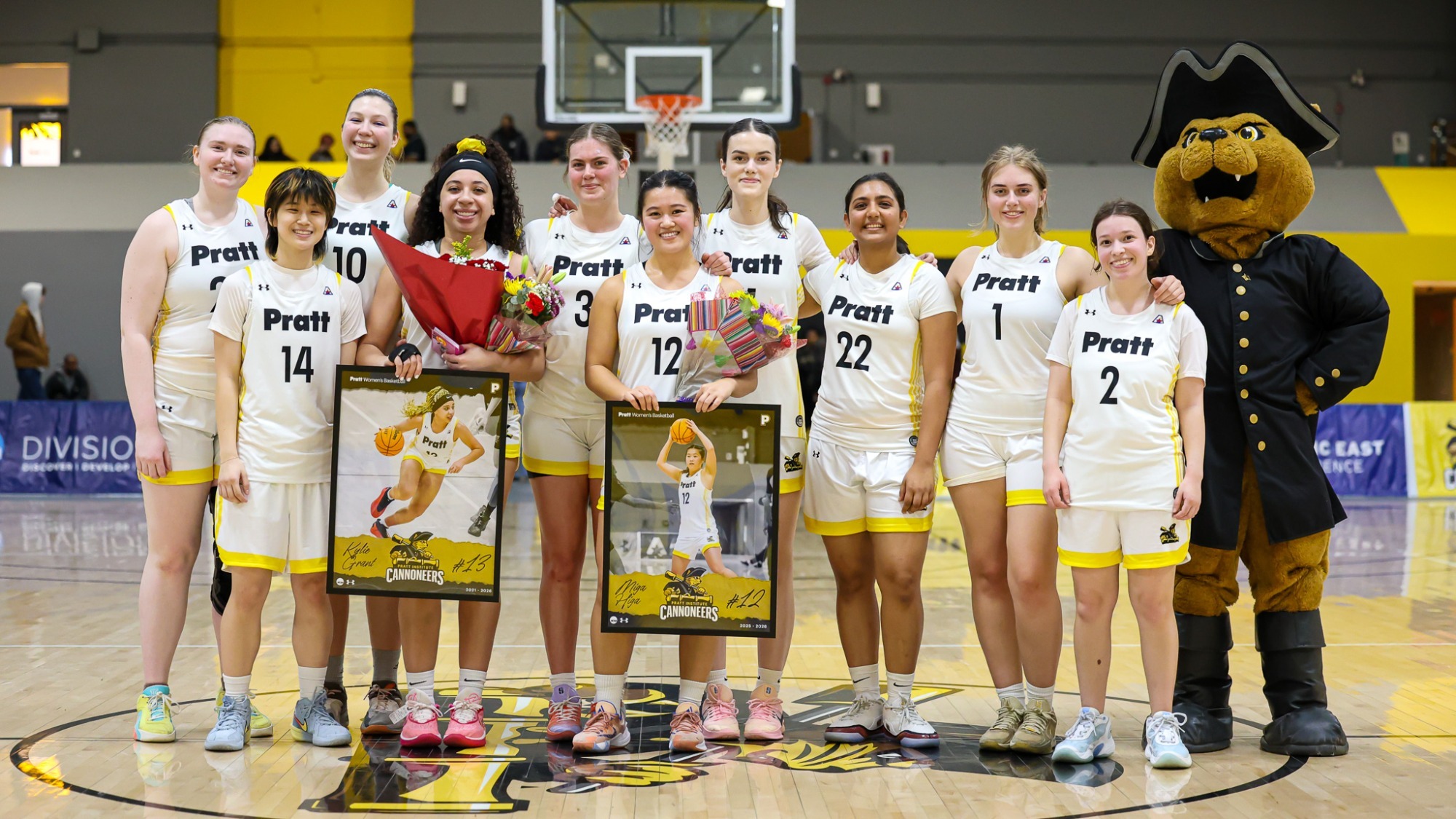 The Pratt Women's Basketball honors their seniors and poses for a photo at halfcourt on Senior Day.