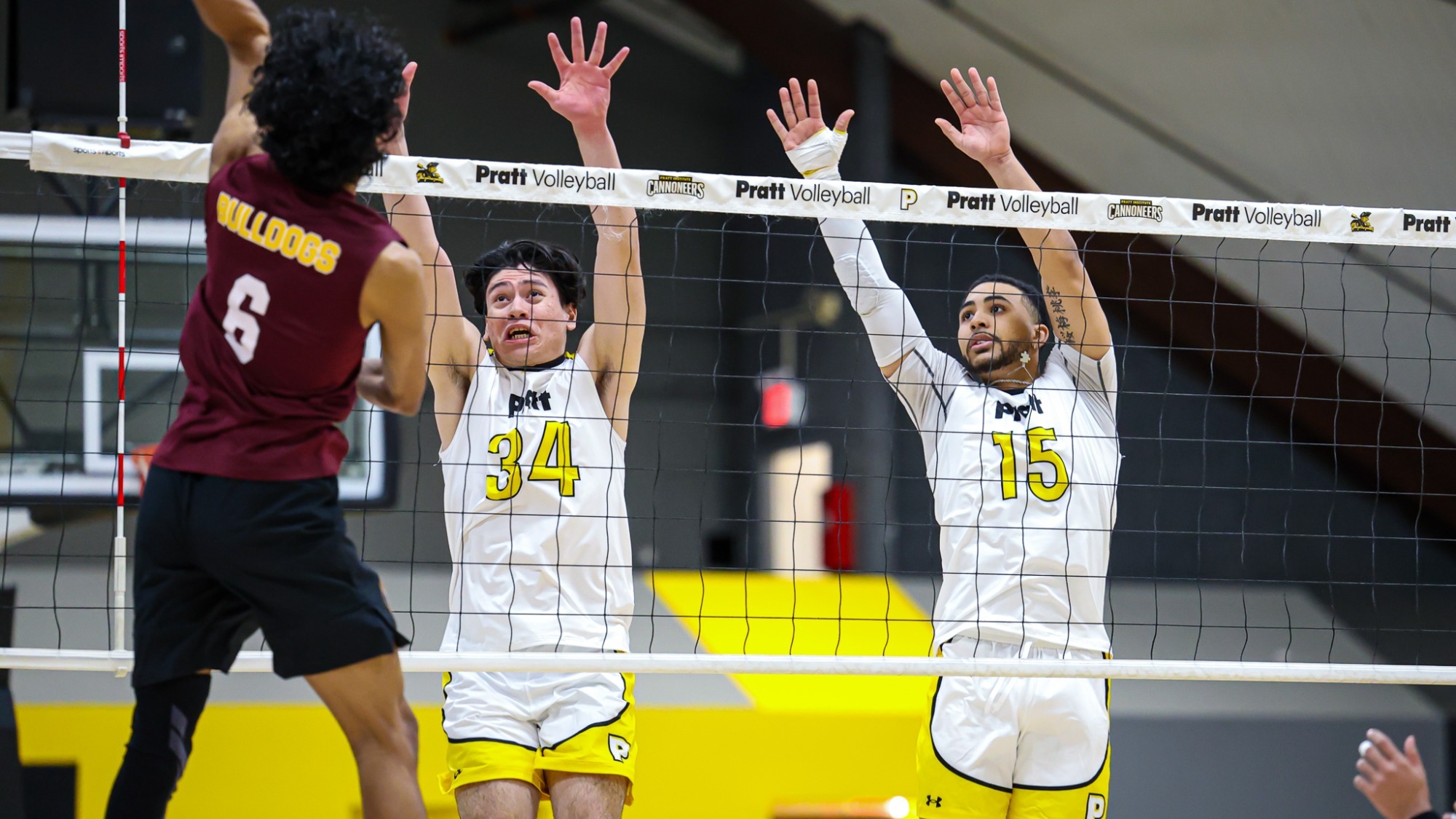 Arturo Mata and Micah Jude-Upshaw jump at the net attempting to block a Brooklyn attacker