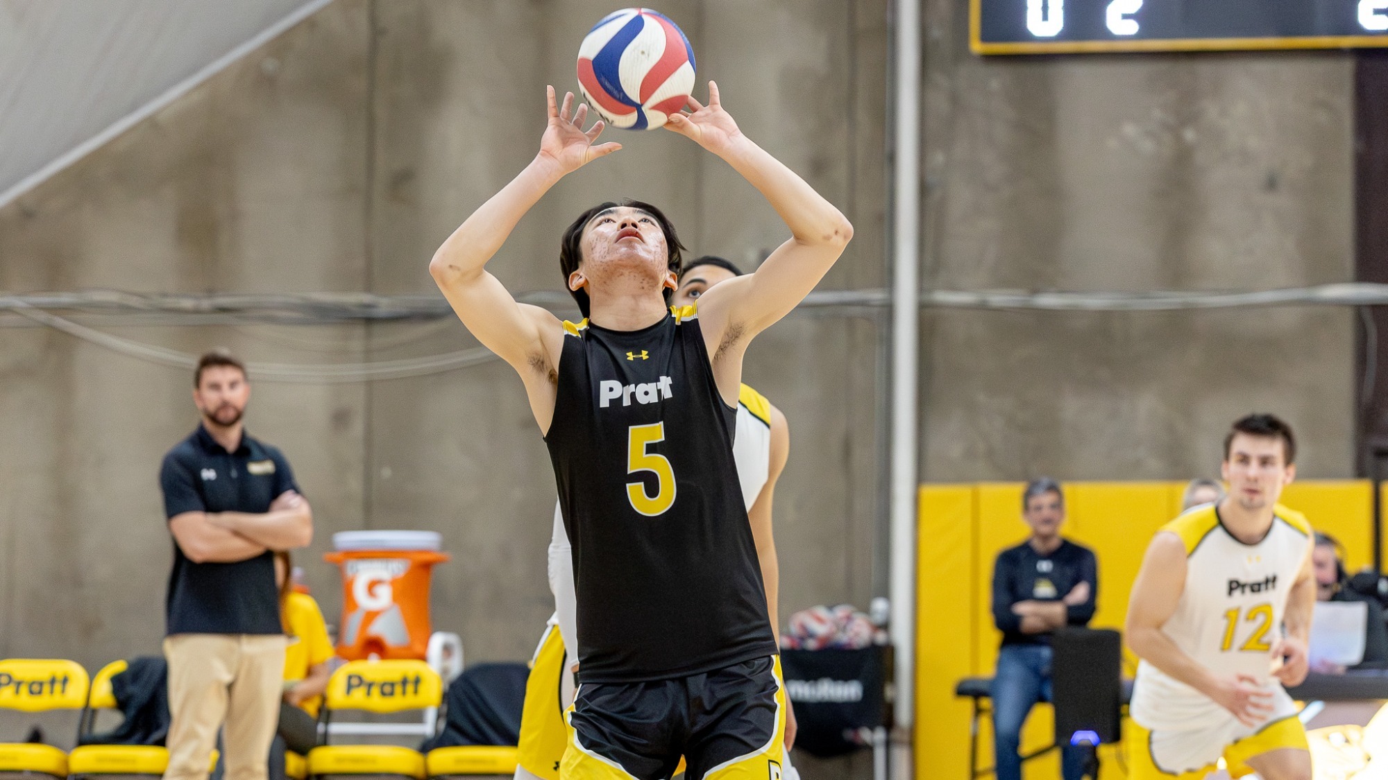 Raymond Liang sets the ball with two hands