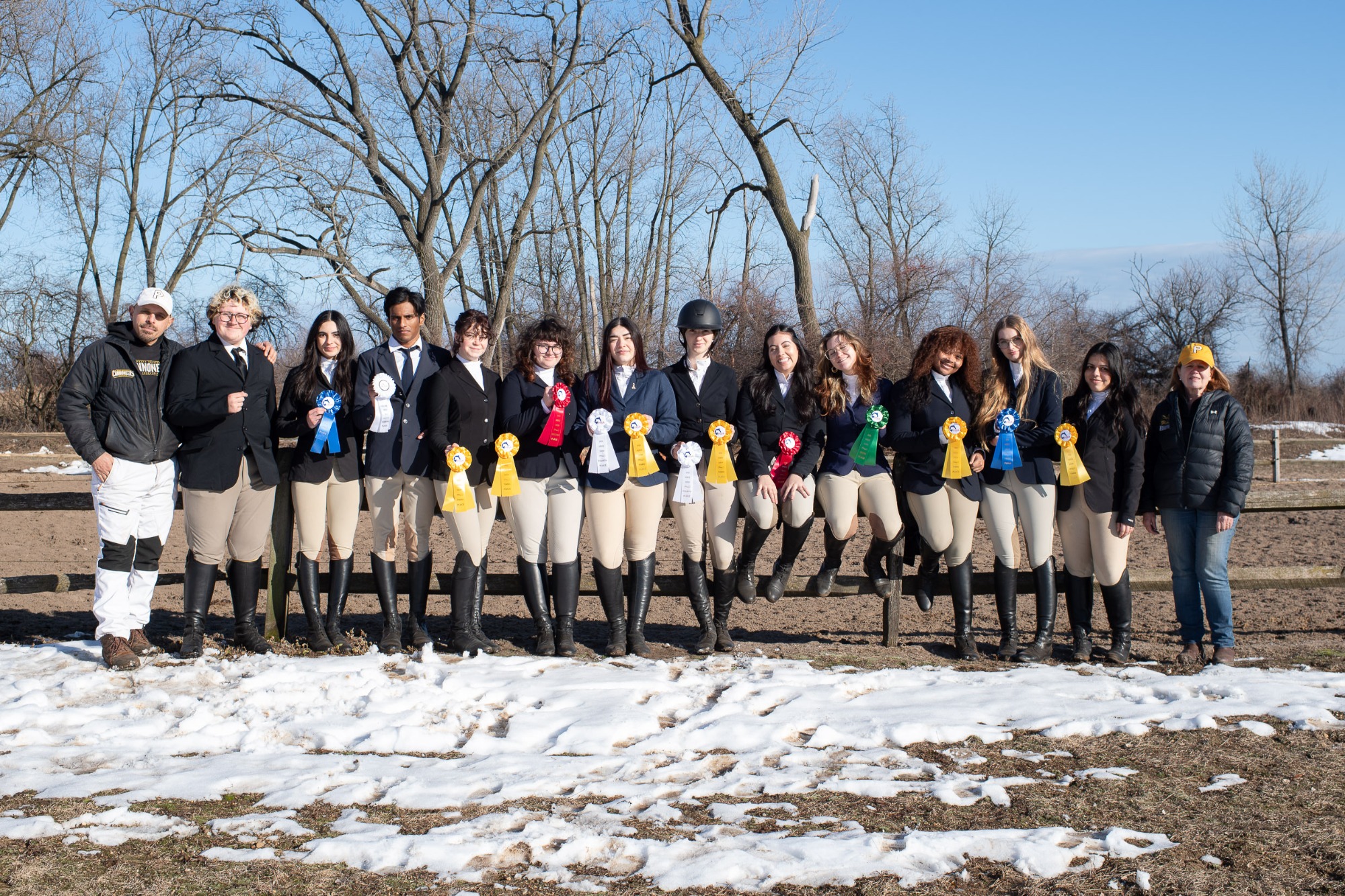 Pratt Equestrian team holding their ribbons after their home show.