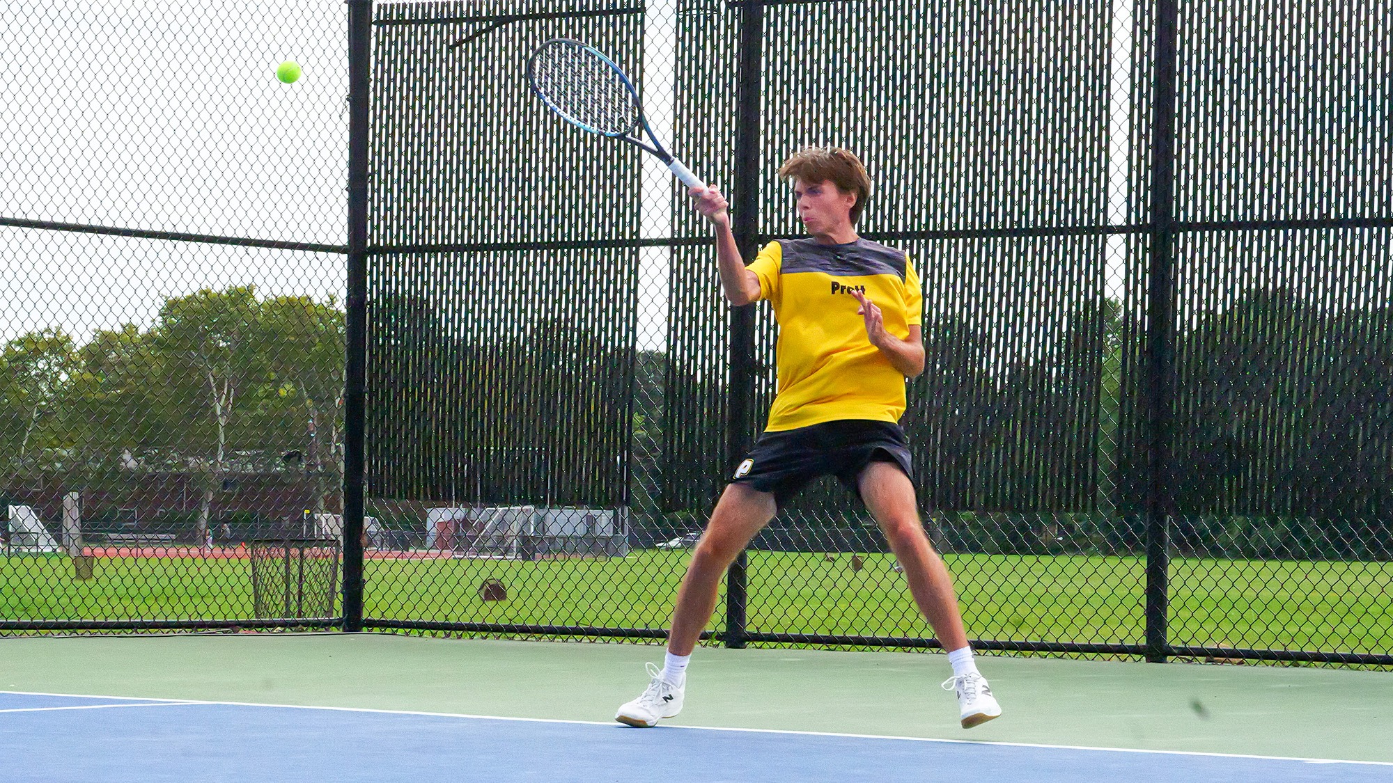 Peter Burnham hits a forehand from the baseline