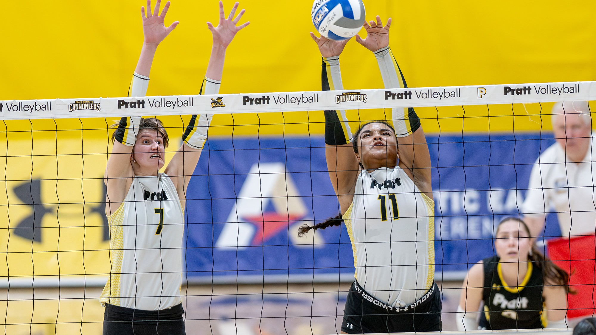 Alison Sontag and Kelsy Padilla jump at the net to block