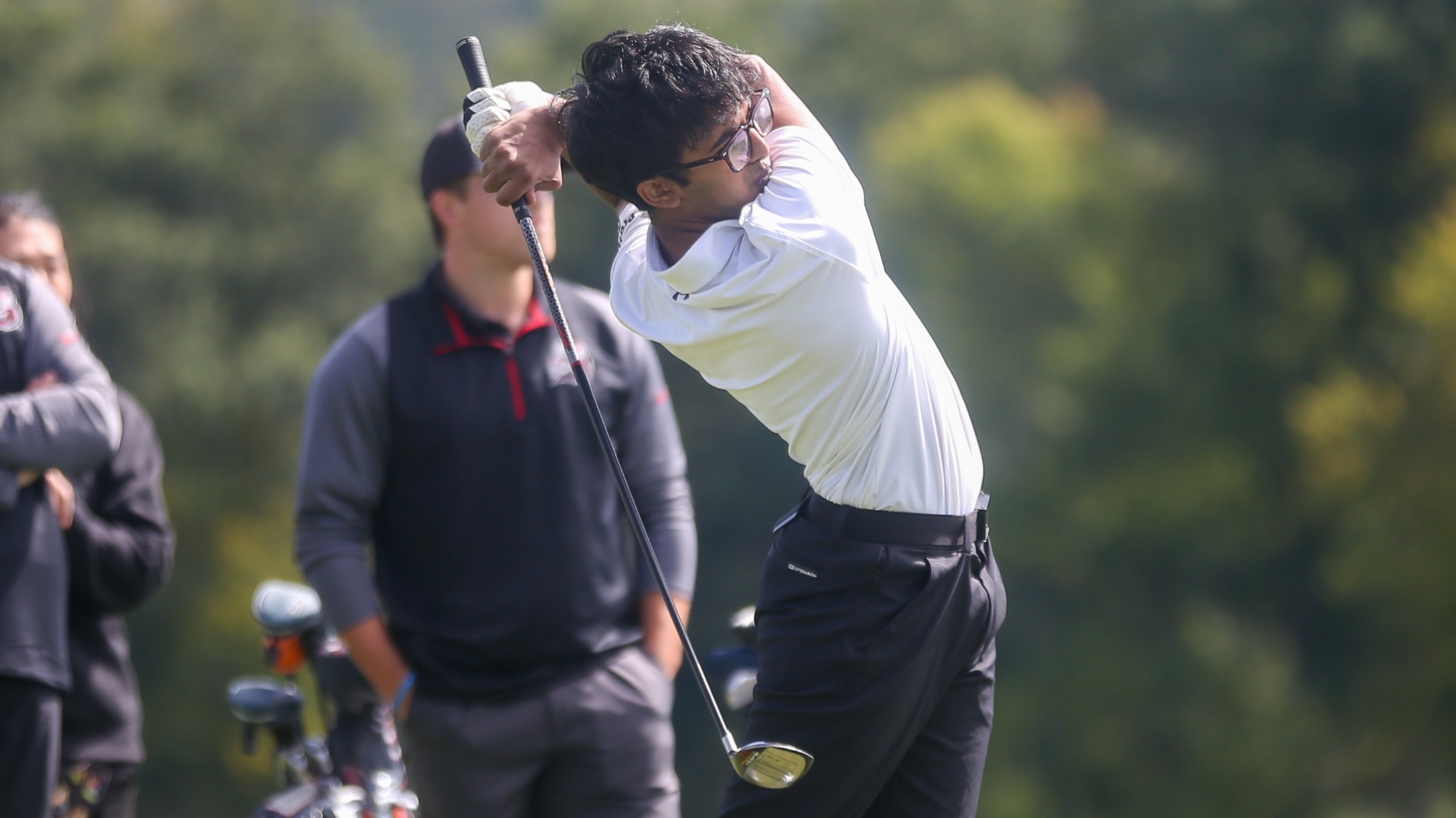 Anirudh Bharath watches after teeing off with a fairway wood