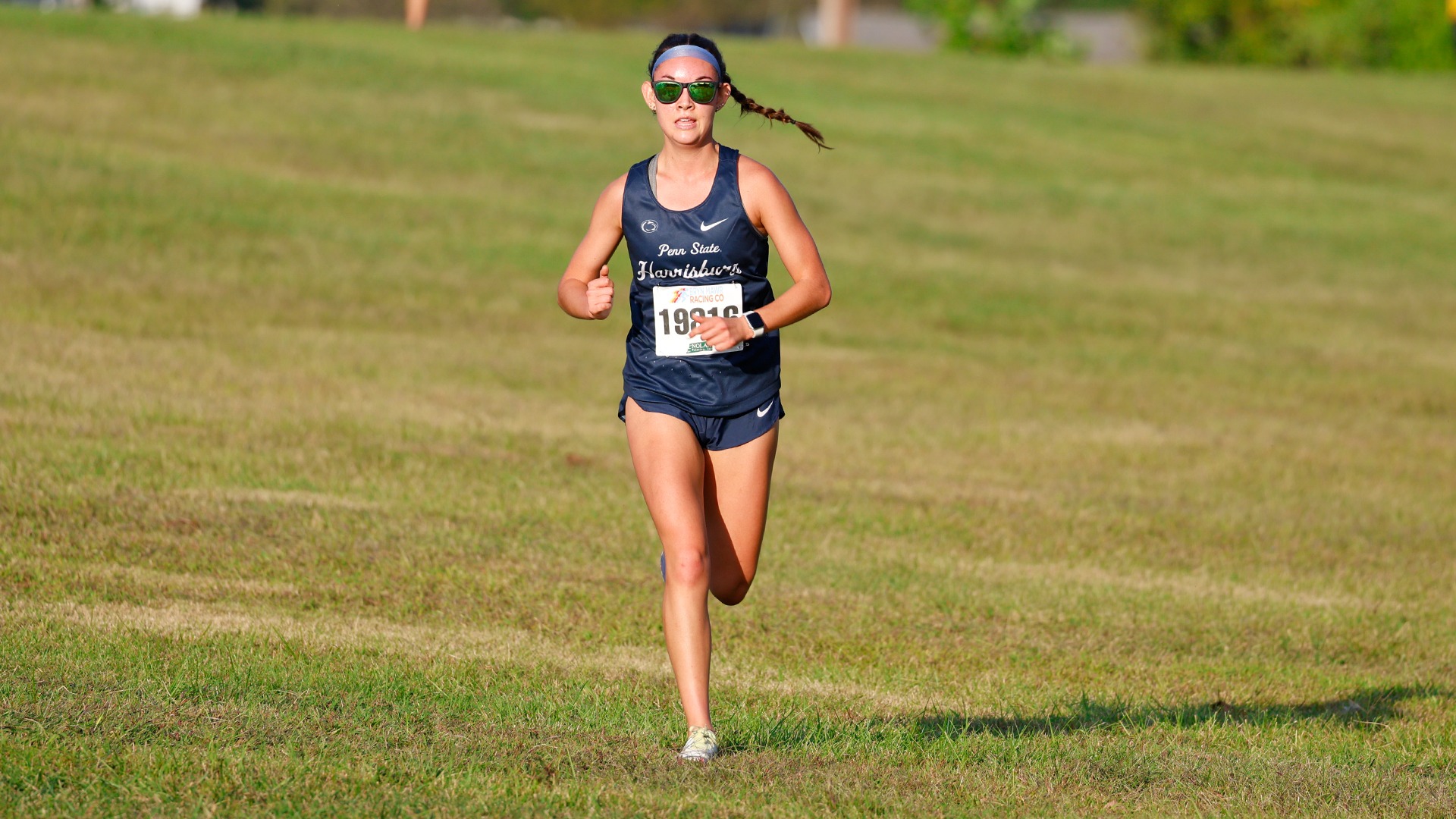makayla reichel runs down a hill towards the finish line at the end of a meet at penn state brandywine in 2025